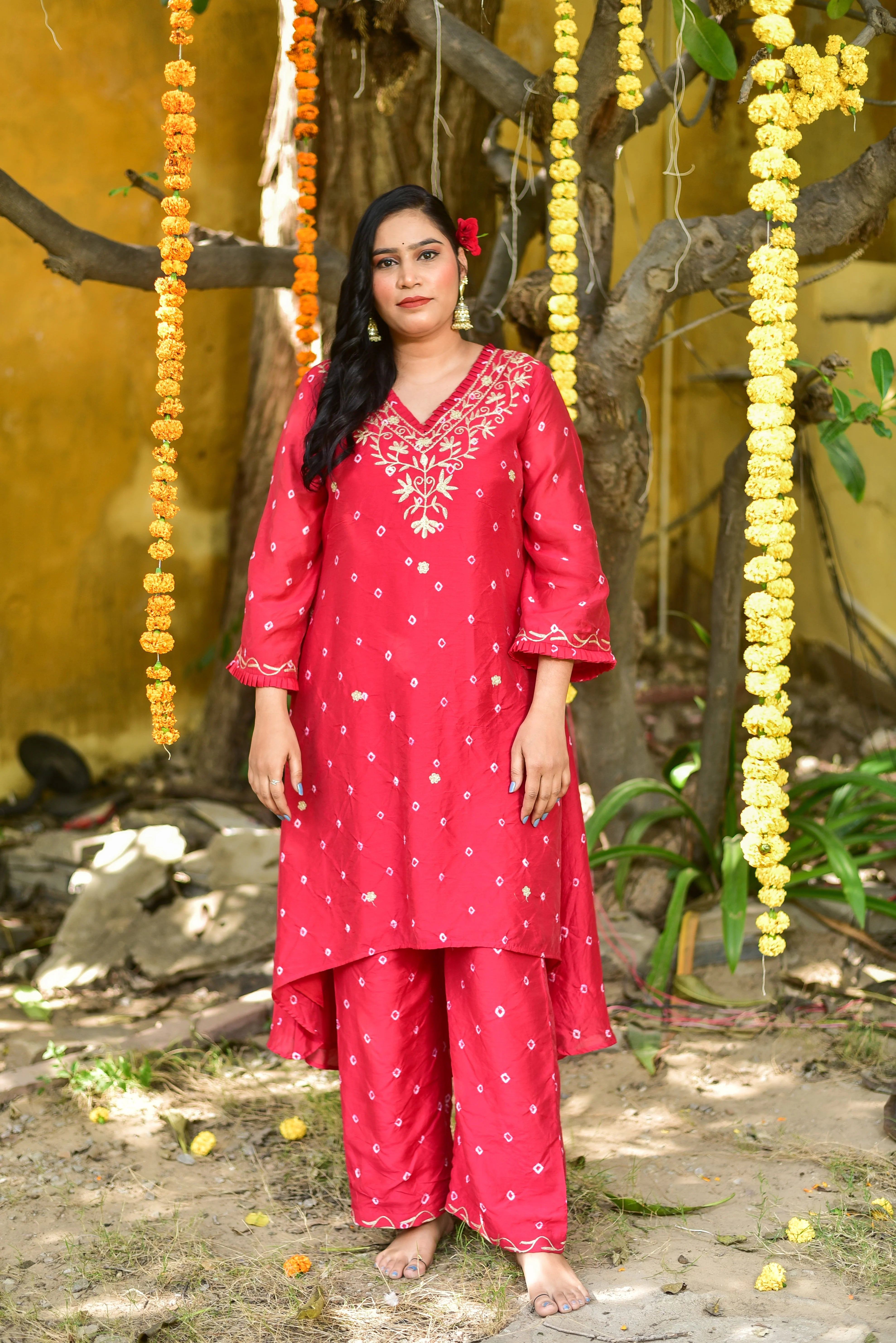 The image showcases a stunning red Bandhej asymmetrical kurta set, exuding elegance and sophistication. The vibrant red hue is perfectly complemented by intricate tie-dye artistry, creating a unique and eye-catching design. The asymmetrical silhouette adds a touch of modernity to the traditional Bandhej pattern, making it a standout piece for any occasion.
This product is perfect for those who want to celebrate tradition with a contemporary twist.
