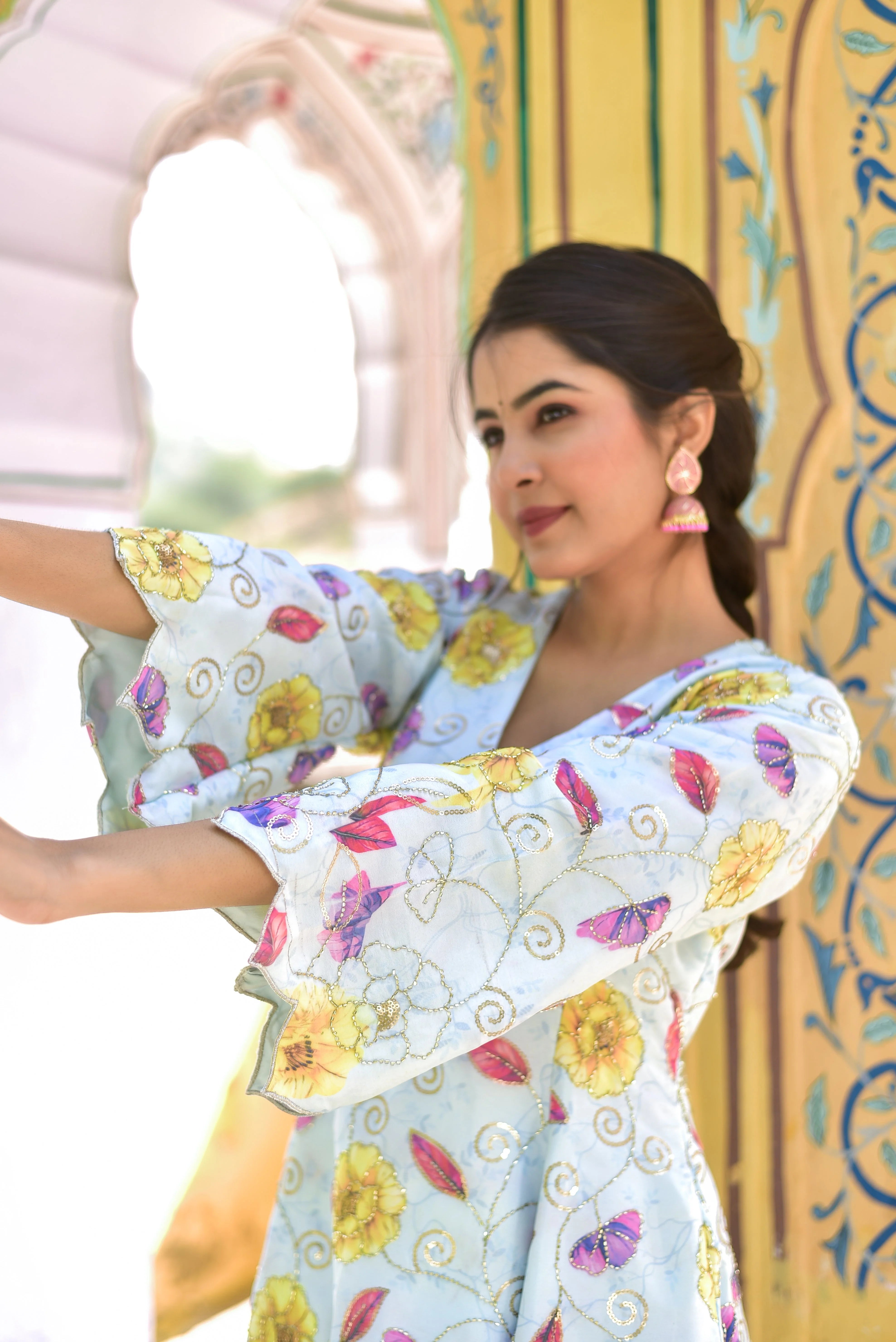 The Blue Morning Mist Floral Kurta Set is a stunning ensemble that captures the essence of a serene morning garden, with delicate blooms dancing across a soft blue and white canvas. The contemporary floral artistry and traditional silhouettes come together in perfect harmony, creating a truly elegant and trendy look.