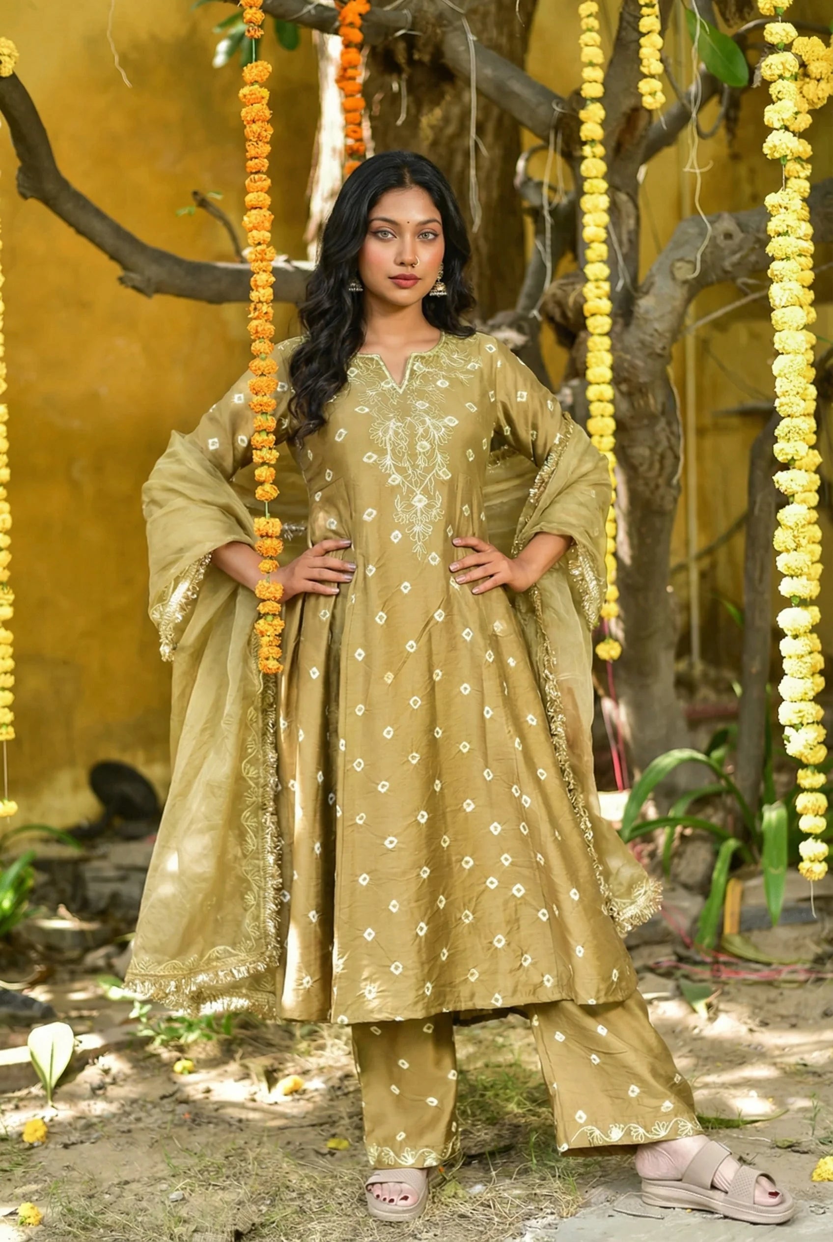 This image showcases a stunning Olive Green Bhandej Kurta Set, exuding timeless elegance and sophistication. The rich olive hue is complemented by intricate bhandej work, adding a regal touch to this festive ensemble. The kurta and pant set are crafted from luxurious fabric, ensuring both comfort and style. With its classic design and vibrant color, this set is perfect for making a statement at any occasion.