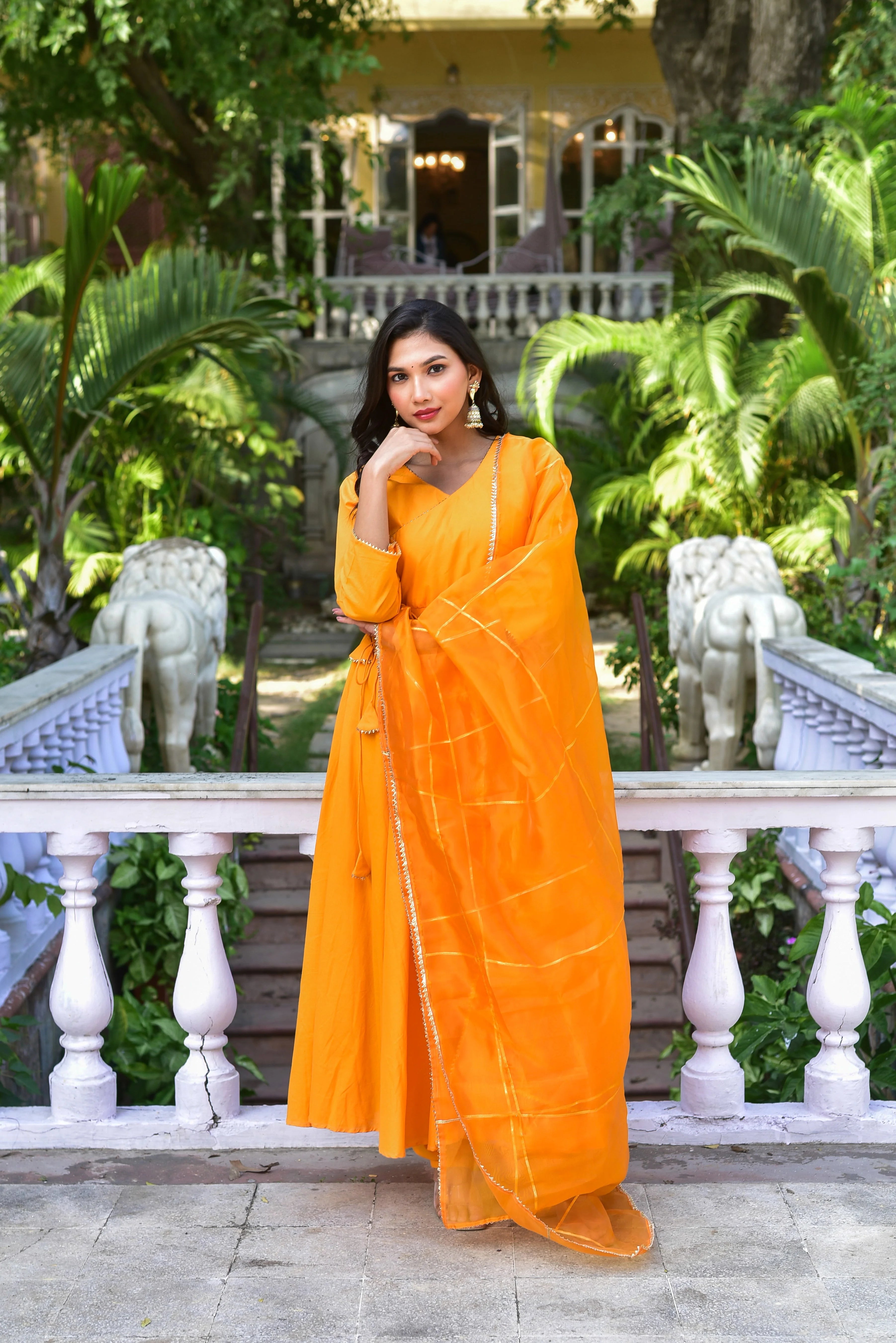 The Haldi Yellow Angrakha Anarkali Set is a stunning and elegant ensemble that embodies the essence of traditional Indian craftsmanship, perfectly suited for the vibrant Holi celebrations. The set features a vibrant haldi yellow hue, exuding warmth and joy, and is crafted from luxurious fabrics such as silk or organza, ensuring a comfortable and stylish fit.