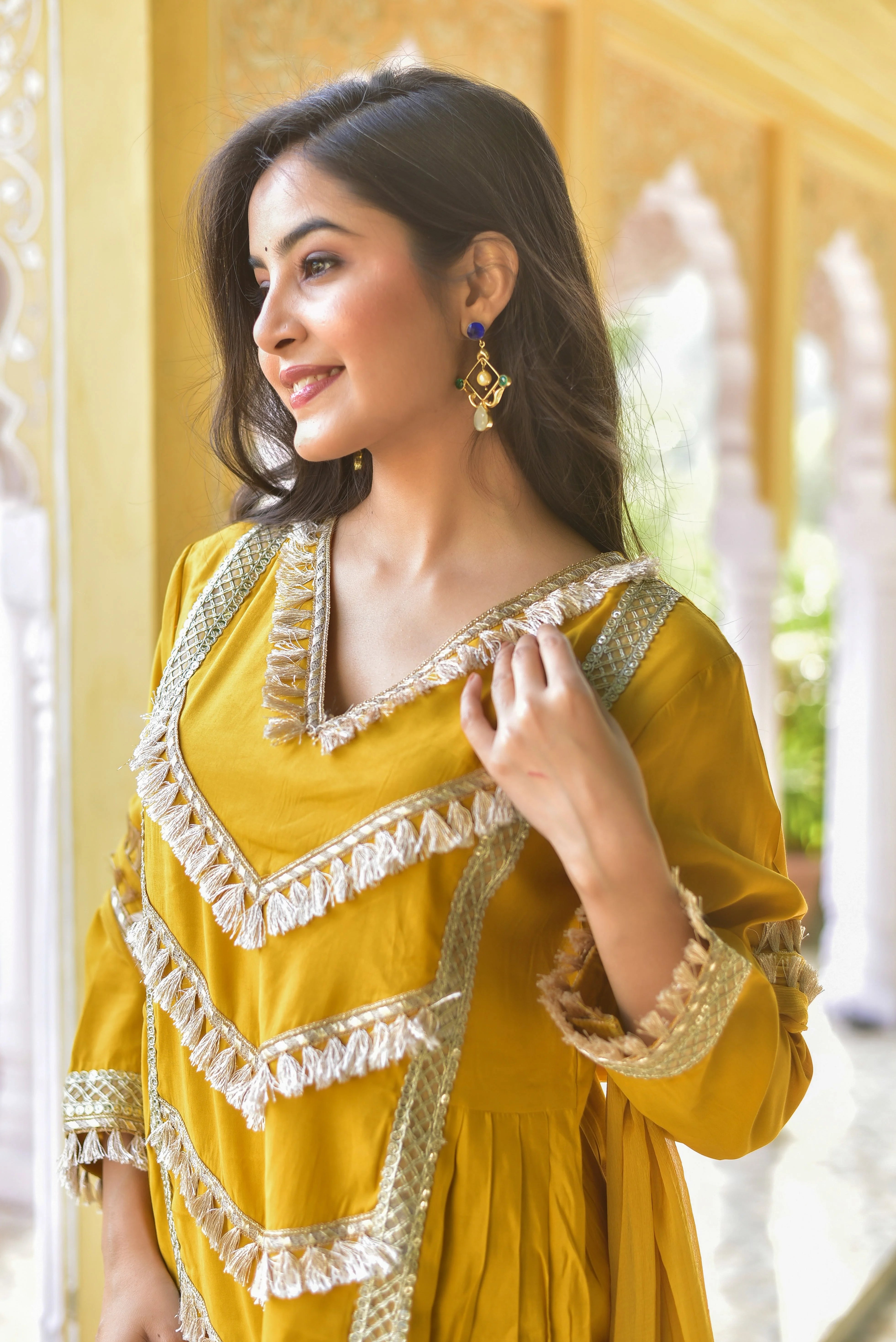 This Yellow Gold Kurta & Pant Set is a stunning ensemble that embodies the perfect blend of traditional elegance and modern flair. The vibrant yellow hue exudes warmth and optimism, while the intricate gold accents add a touch of sophistication and luxury. The kurta's flowy design and V-neckline create a flattering silhouette, while the matching pants provide a comfortable and stylish bottom half.
