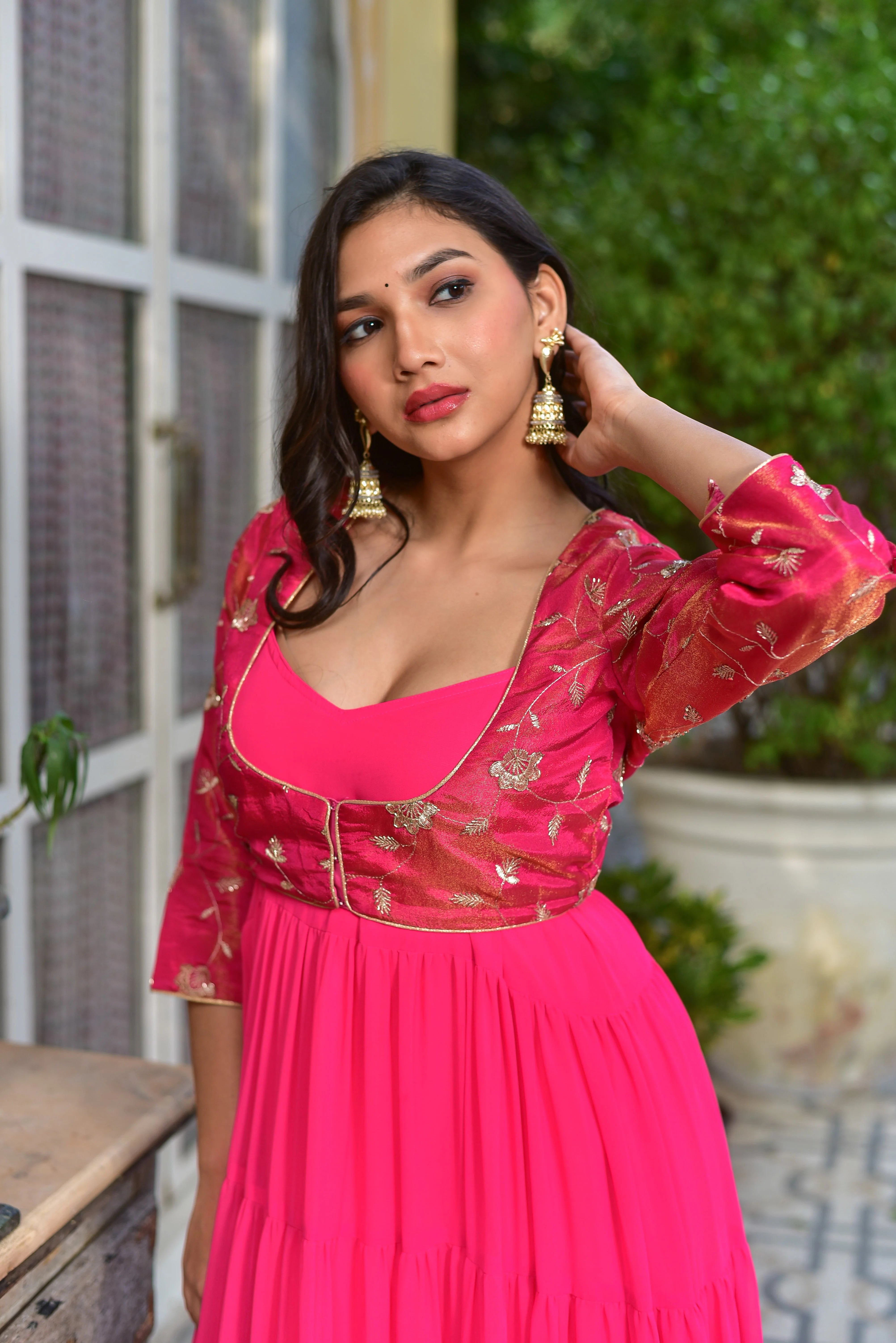 The pink stunning tired dress with jacket is a masterful blend of contemporary silhouettes and traditional craftsmanship, making it a show-stopping choice for any celebration. The flowing georgette dress features delicate tiers that create a beautiful, flowing movement with every step, while the coordinating jacket adds an extra layer of elegance with its intricate details. The dress is crafted from high-quality fabric, ensuring a comfortable and luxurious feel against the skin.