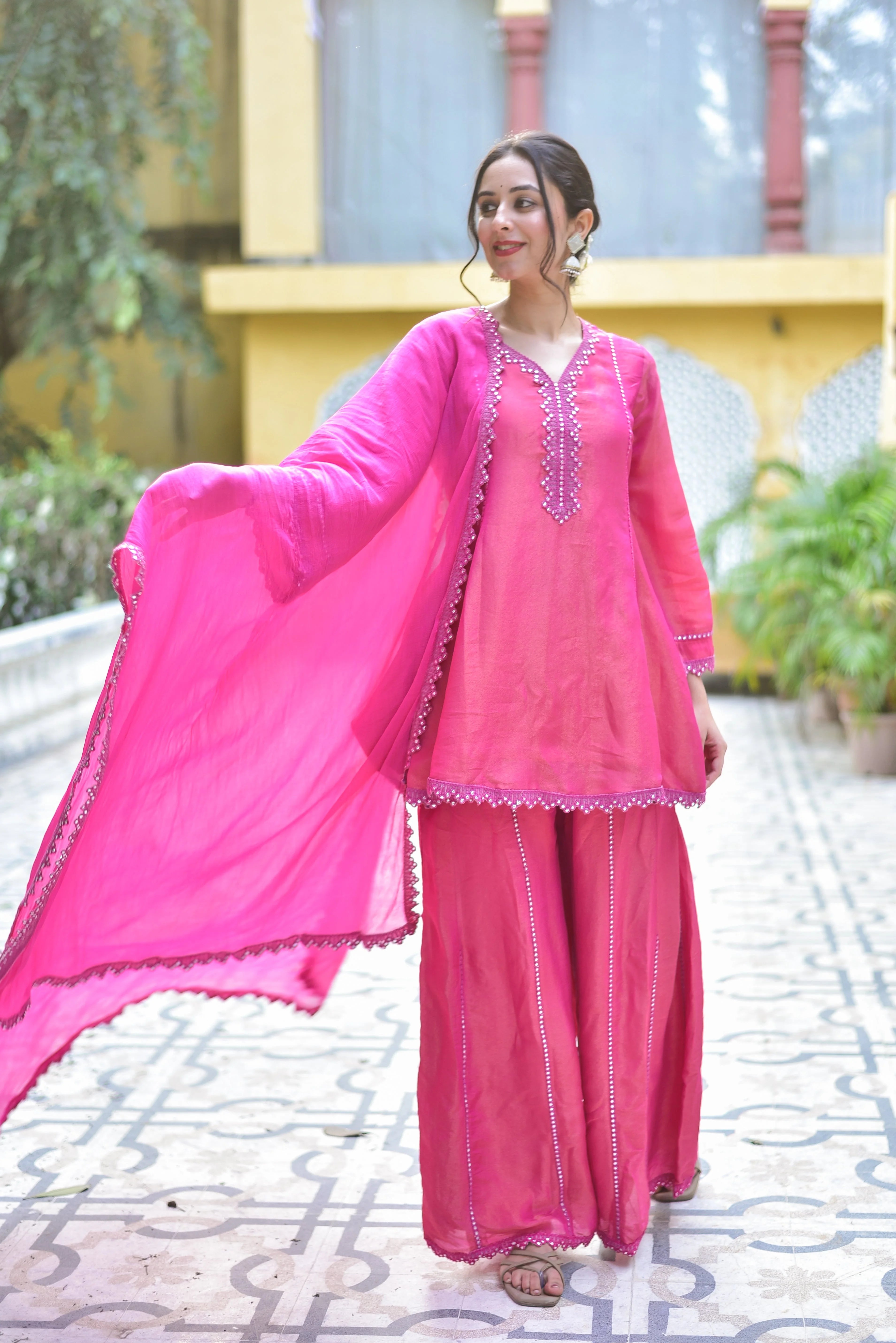 The Pink Zari Silk Kurta Sharara Set is a stunning ensemble that exudes elegance and sophistication. Crafted from luxurious silk, the kurta features intricate zari embroidery that adds a touch of opulence to the overall design. The matching sharara pants complement the kurta perfectly, creating a harmonious and balanced look. The set is completed by a beautiful dupatta, adding a pop of color and texture to the overall ensemble.
