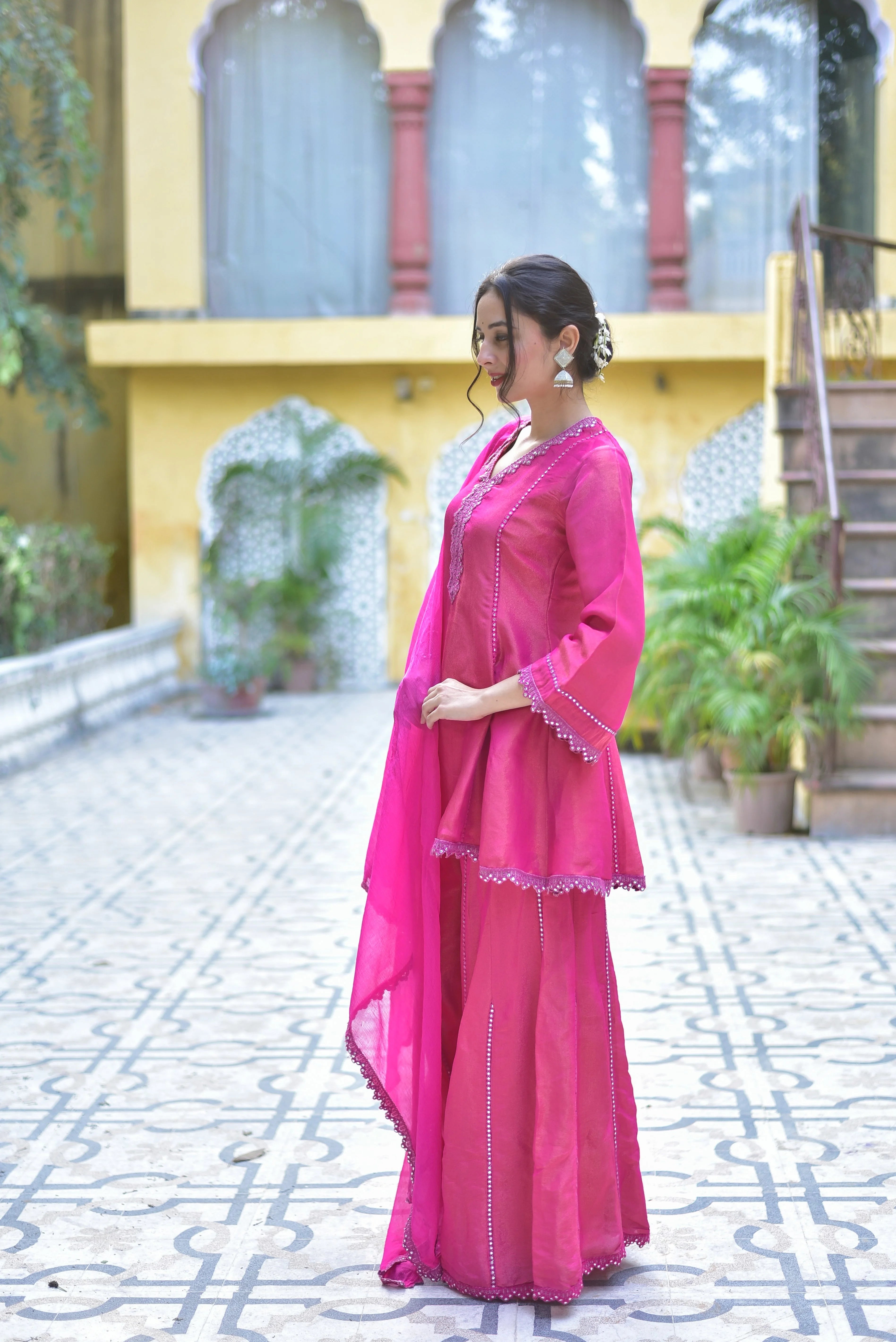 The Pink Zari Silk Kurta Sharara Set is a stunning ensemble that exudes elegance and sophistication. The vibrant pink hue of the silk fabric is accentuated by intricate zari embroidery, creating a regal and luxurious look. The kurta's flowing silhouette and delicate bell sleeves add to its feminine charm, while the sharara's flared design creates a dramatic flair. This set is perfect for special occasions, such as weddings and festivals, and is sure to make a statement.