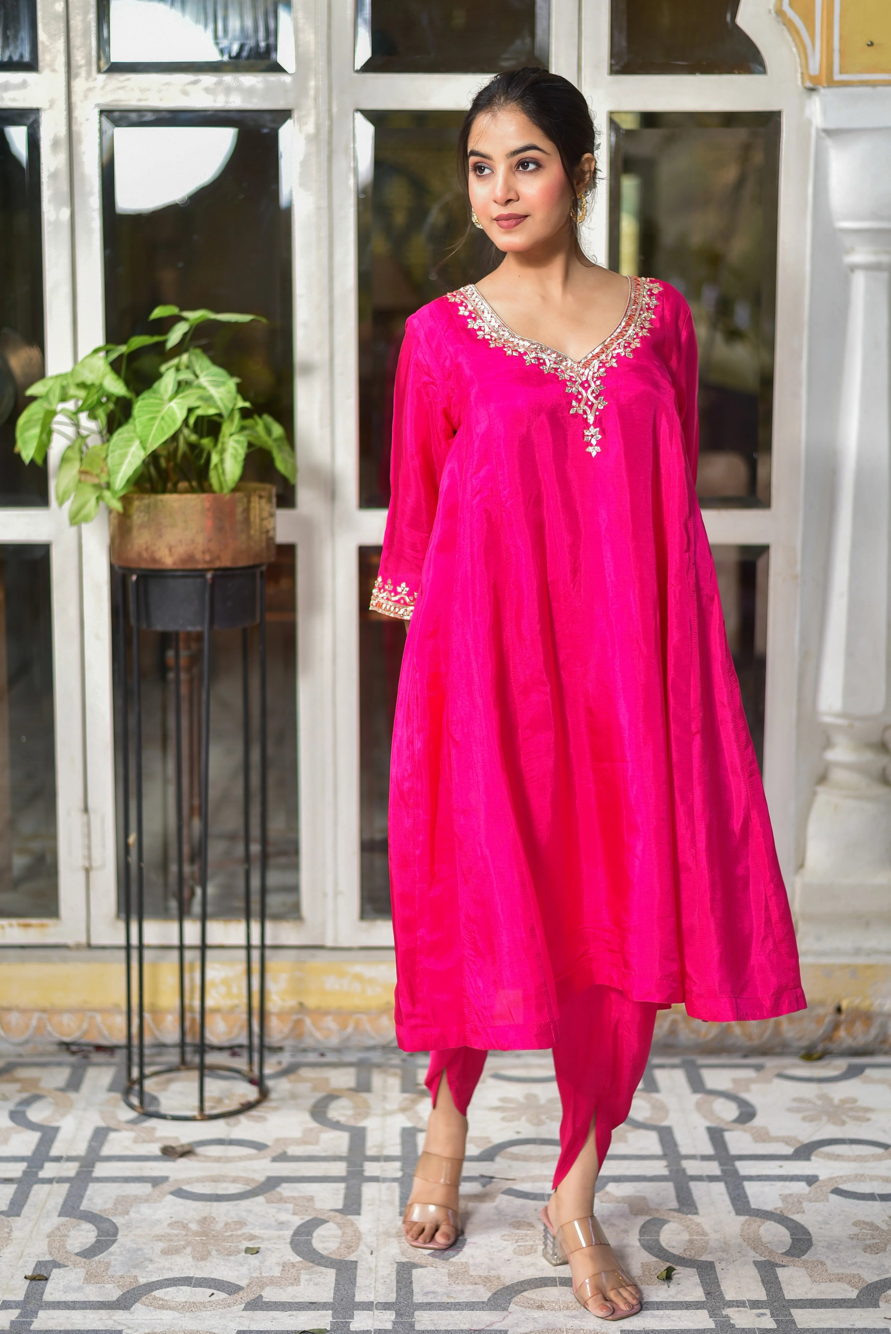 The Rani Pink Punjabi Style Kurta & Dhoti Set is a stunning example of traditional Indian craftsmanship, exuding elegance and sophistication. Crafted from luxurious silk, this ensemble boasts a rich, vibrant pink hue that commands attention. The kurta features intricate embroidery on the neckline and sleeves, adding a touch of regality to the overall design. The flowing dhoti pants complete the look, creating a fluid silhouette that drapes beautifully on the body.