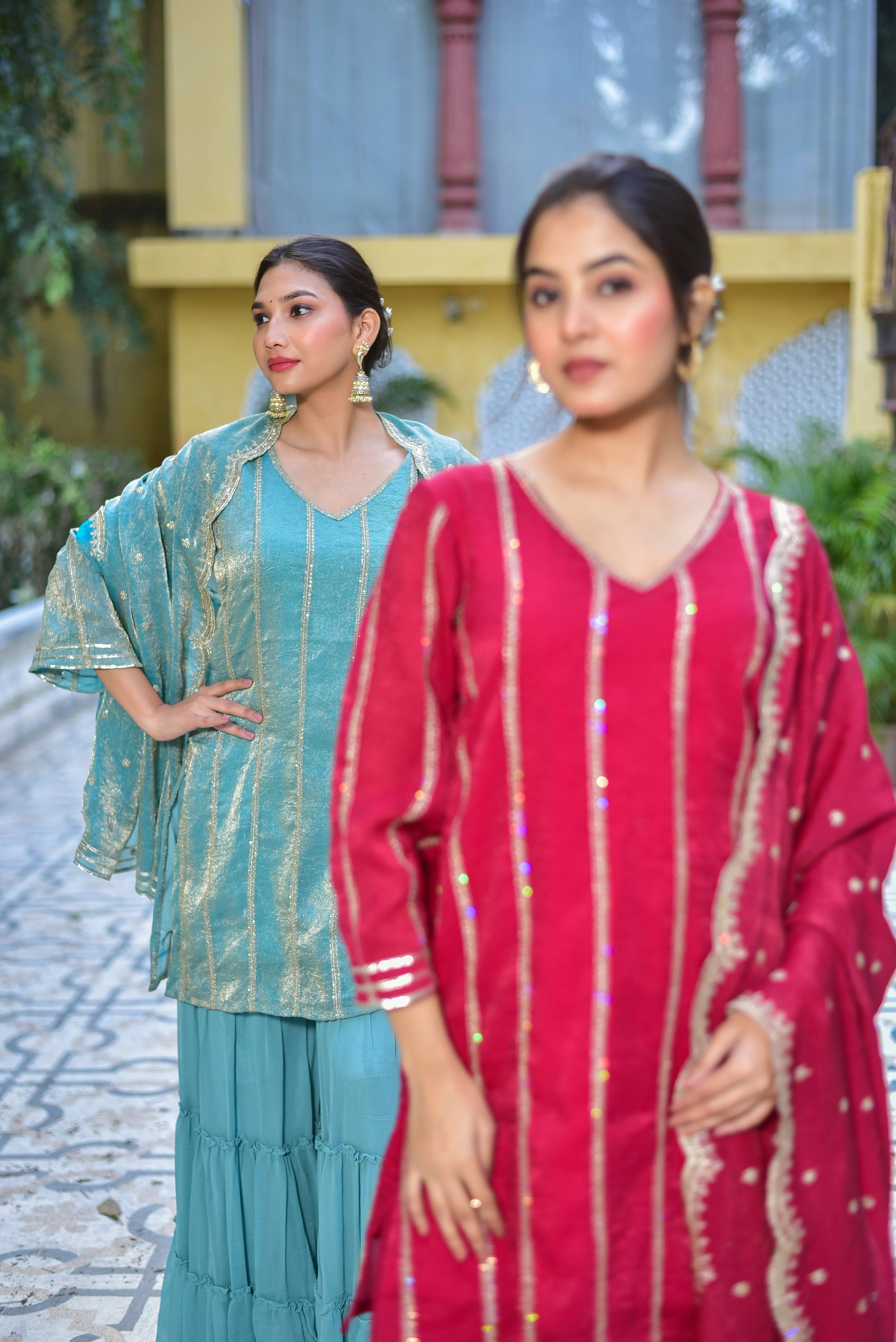 The image showcases a stunning Sea Green Kurta Sharara Set, exuding elegance and sophistication. This traditional Indian ensemble features a vibrant sea green hue, complemented by intricate gold accents that add a touch of luxury. The kurta boasts a V-neckline and three-quarter sleeves, while the sharara pants are designed with a tiered style, creating a flowy and feminine silhouette. A matching dupatta completes the set, adding an extra layer of grace and poise.