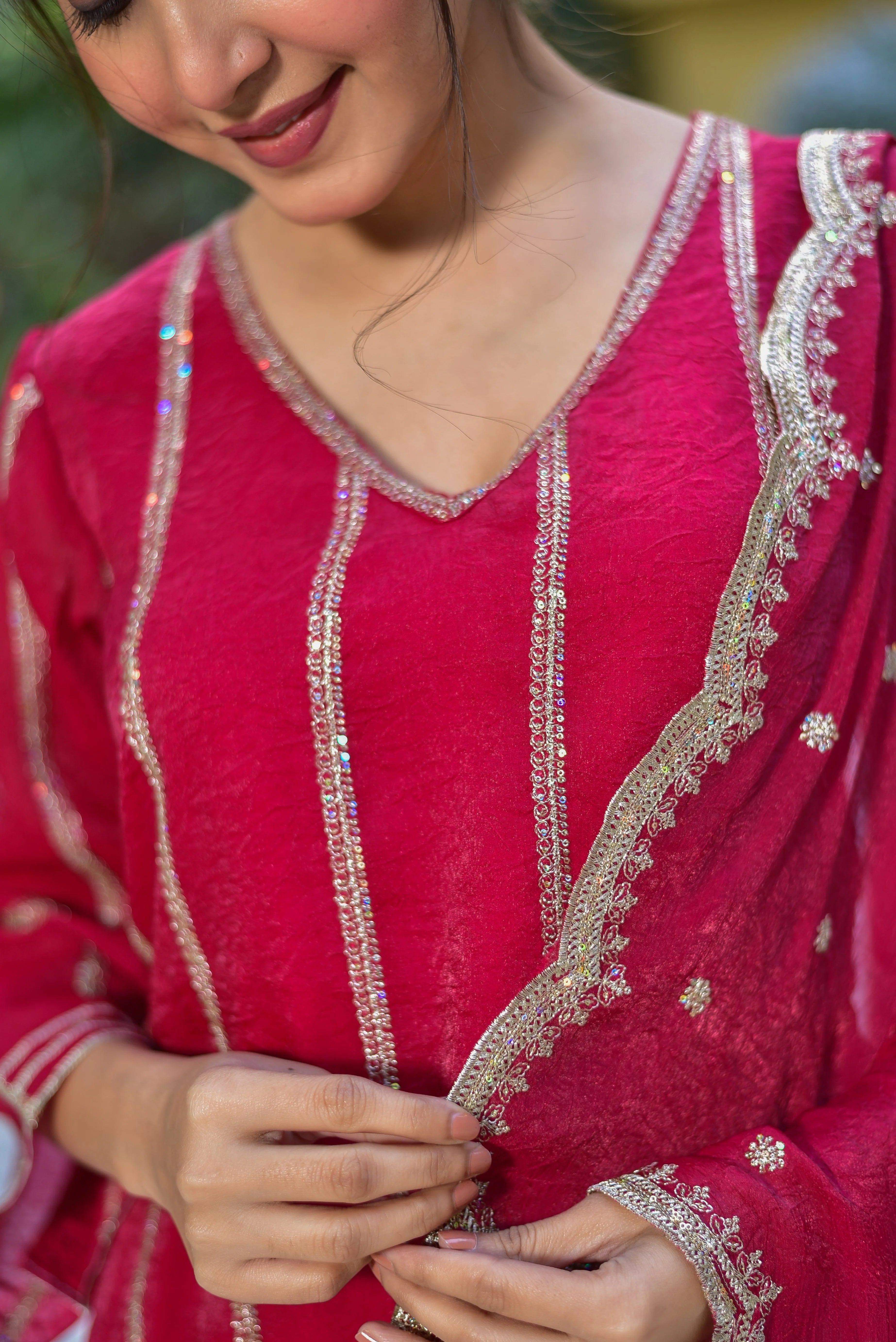 The Magenta Heavy Sharara Set: A Masterpiece of Artisanal Elegance
Elevate your style with this exquisite ensemble, perfect for making a statement at festive occasions and special gatherings. The rich magenta hue is complemented by intricate embroidery, adding a touch of regal sophistication to your look. Crafted from luxurious fabrics, this set exudes timeless elegance and is sure to turn heads.