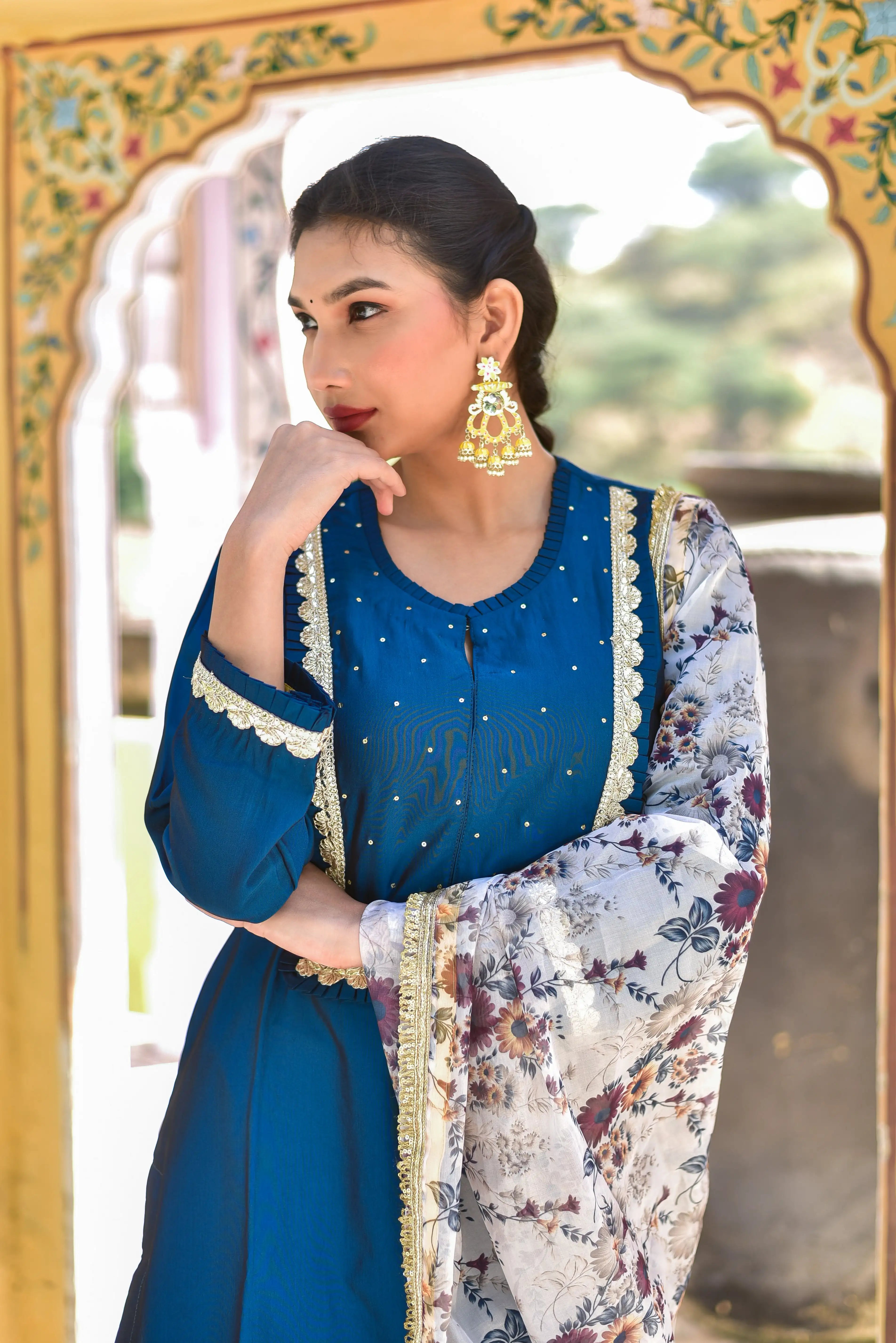 This Peacock Blue Kurta & Pant Set exudes regal sophistication, featuring a rich peacock blue hue that embodies traditional Indian heritage. The elegant design is complemented by a beautiful floral dupatta, adding a touch of artistic elegance to the ensemble. Crafted from high-quality fabric, this set is perfect for making a statement at any formal occasion. With its stunning color and intricate details, it's sure to turn heads and make you feel like royalty.