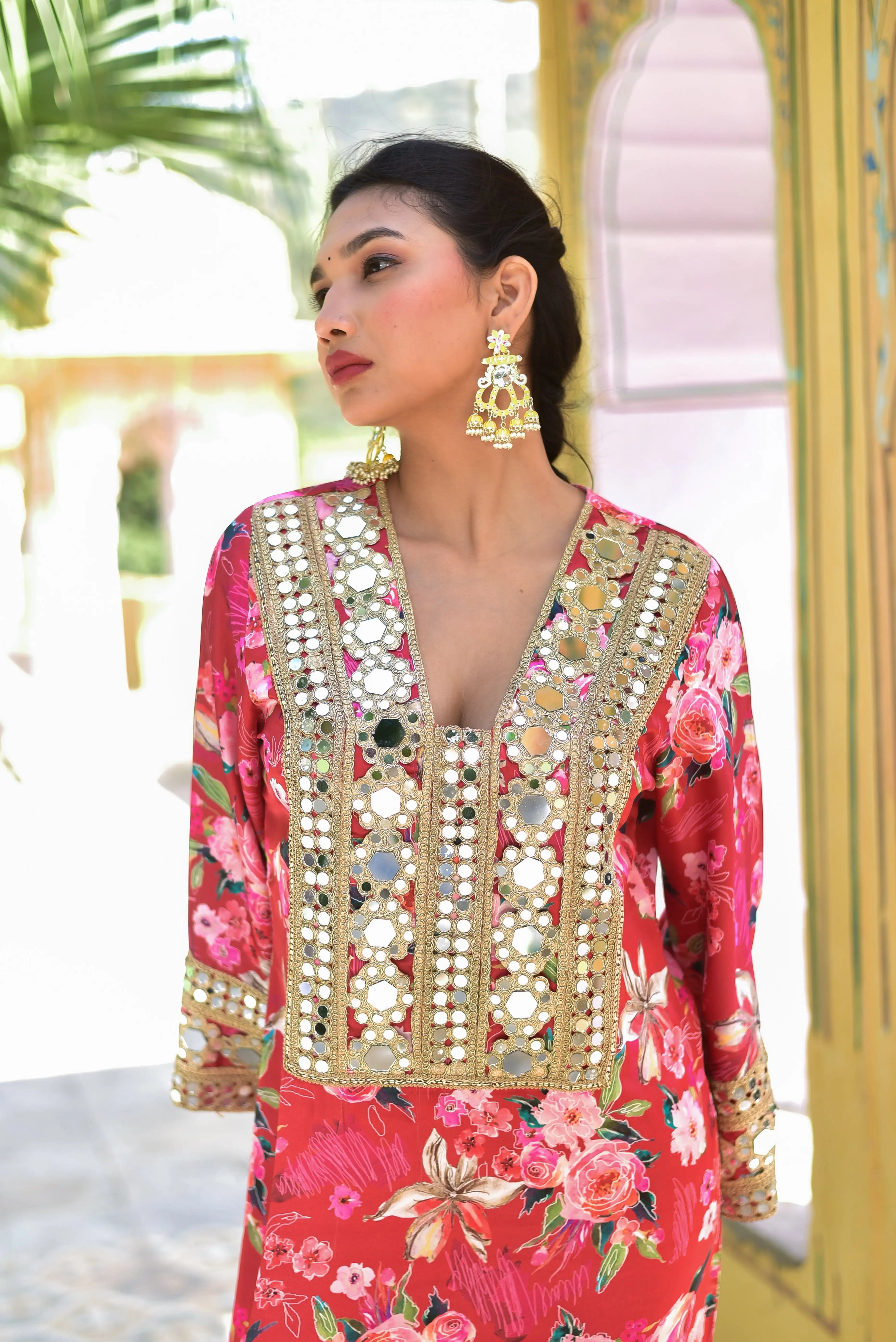 The image depicts a woman wearing a stunning floral rosy satin afghani dress, adorned with intricate mirror embellishments and digital floral prints. The dress features a V-neckline, long sleeves, and a flowing silhouette, showcasing the perfect blend of elegance and sophistication.
This exquisite piece is crafted from luxurious satin fabric, boasting a vibrant rosy hue that exudes warmth and charm.