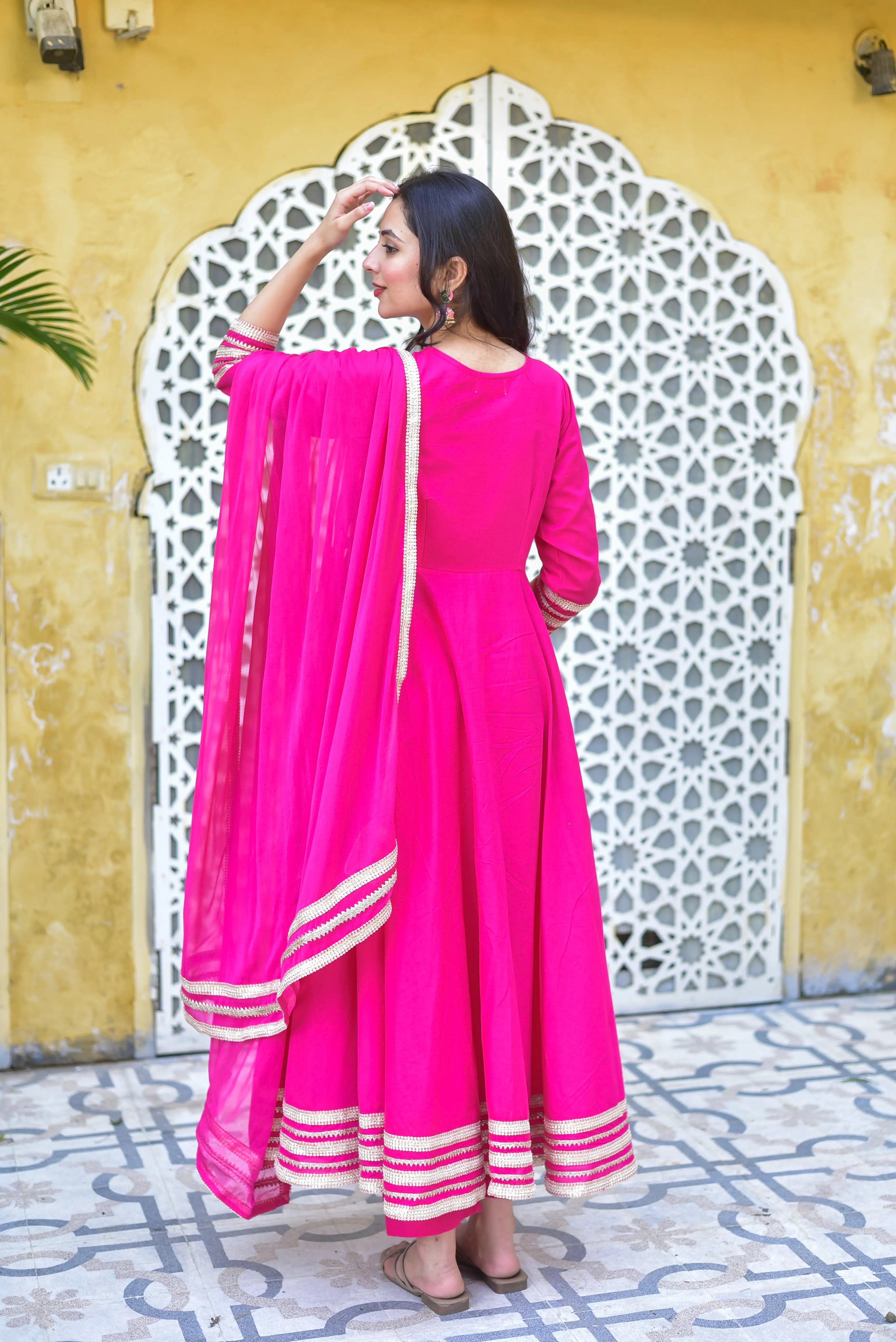 The Rani Pink Anarkali Set is a vibrant and elegant ensemble that exudes joy and celebration. The rich fuchsia hue of the anarkali dress is a timeless favorite for festive occasions, bringing energy and elegance to every gathering. The intricate embroidery on the dress adds a touch of sophistication, while the flowy silhouette creates a dramatic and regal effect. This set is perfect for making a bold statement at any celebration, whether it's a wedding, festival, or special event.
