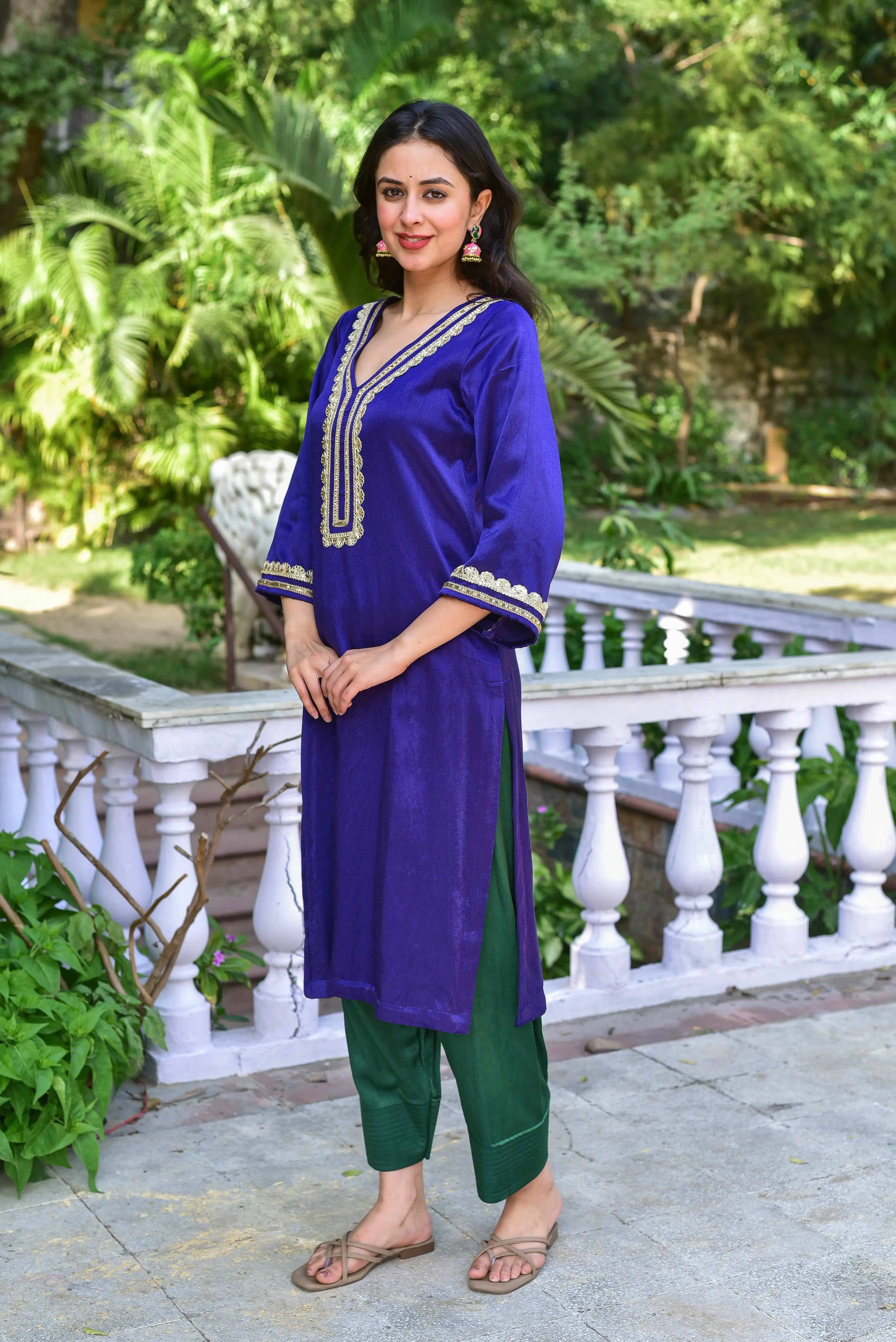 The Truffle Silk Ensemble is a stunning kurta set crafted from a luxurious silk blend, showcasing the perfect marriage of rich fabric and exquisite detailing. The deep royal blue hue evokes timeless sophistication, while intricate gold embroidery adds a touch of elegance to the neckline and cuffs. The three-quarter sleeves and V-neckline create a flattering silhouette, while the straight fit of the kurta and slim-fit pants make it perfect for both formal and semi-formal occasions.