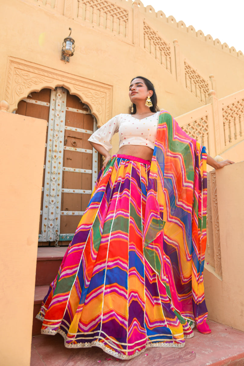 Woman wearing a colorful traditional outfit in front of a beige architectural background