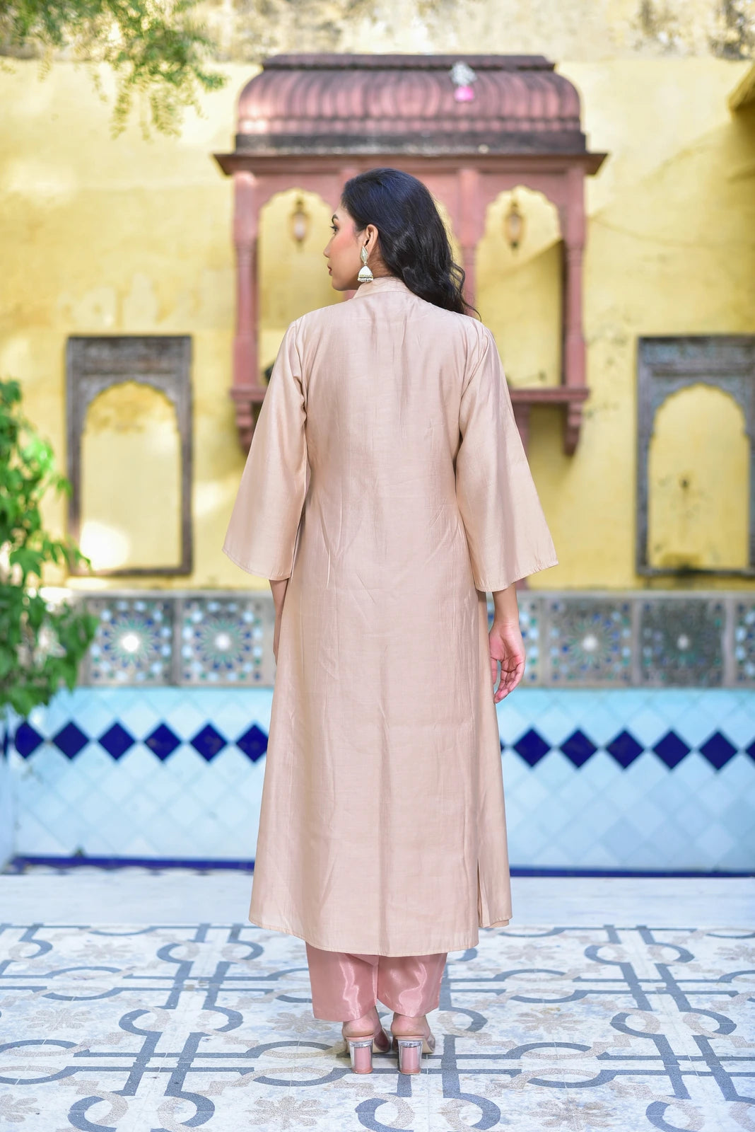 The Royal Rasmalai Pleated Kurta Set is a stunning 2-piece ensemble that brings together traditional charm and contemporary style. Crafted from luxurious fabric, this elegant set features a pleated kurta with a high neckline and flared sleeves, paired with matching pants for a complete look. The intricate pleats add a touch of sophistication, making it perfect for any special occasion or formal event. With its unique blend of traditional and modern elements, this set is sure to make a statement.