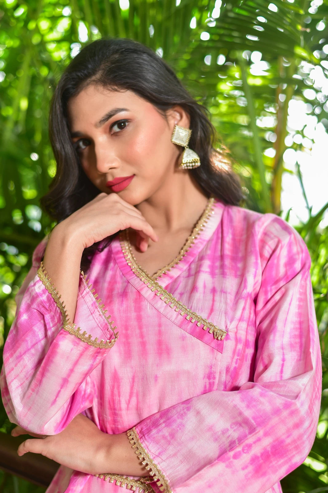 The Roseberry Pink Shibori Co-ord Set is a stunning 3-piece ensemble that showcases exquisite hand tie-dye shibori patterns, perfect for making a statement at festive occasions. This contemporary set combines traditional artisan techniques with modern silhouettes, featuring a roseberry pink hue and elegant gold accents. The set includes a top, bottom, and scarf, all crafted from high-quality fabric for a comfortable and stylish fit.