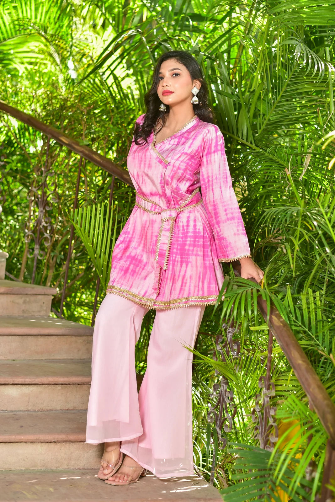 The Roseberry Pink Shibori Co-ord Set is a stunning 3-piece ensemble that showcases exquisite hand tie-dye shibori patterns. This contemporary set combines traditional artisan techniques with modern silhouettes, making it perfect for festive occasions and special events. The set features a roseberry pink color, which is both elegant and trendy, and is made from high-quality fabric that ensures comfort and durability.