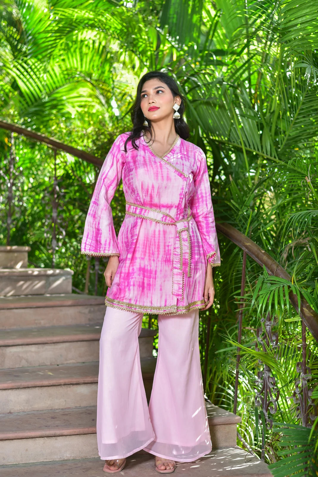 The Roseberry Pink Shibori Co-ord Set is a stunning 3-piece ensemble that showcases exquisite hand tie-dye shibori patterns. This contemporary set combines traditional artisan techniques with modern silhouettes, making it perfect for festive occasions and special events. The set features a roseberry pink hue, which is both elegant and trendy, and is crafted from high-quality fabrics that provide comfort and durability.
