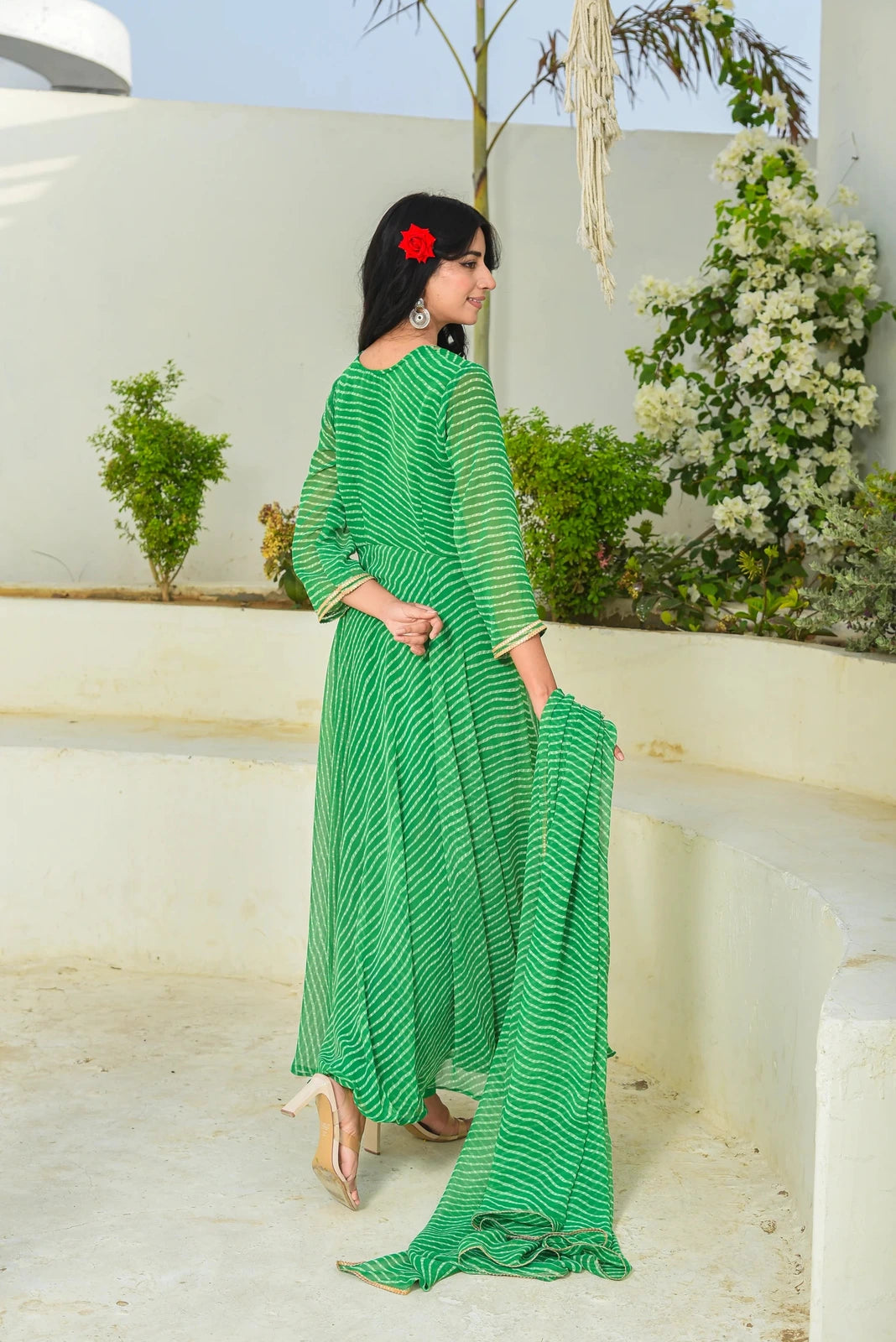 This enchanting green Mothada Umbrella Lehenga Set is a masterpiece of elegance and style, featuring a sweetheart neckline, 3/4 sleeves, and a Modhada print that exudes sophistication. The set includes a lehenga with a hook placket and zip, a blouse with a hook placket closure, and a dupatta with lace detailing. Perfect for festive occasions, this set is a must-have for those who appreciate the beauty of traditional Indian attire.