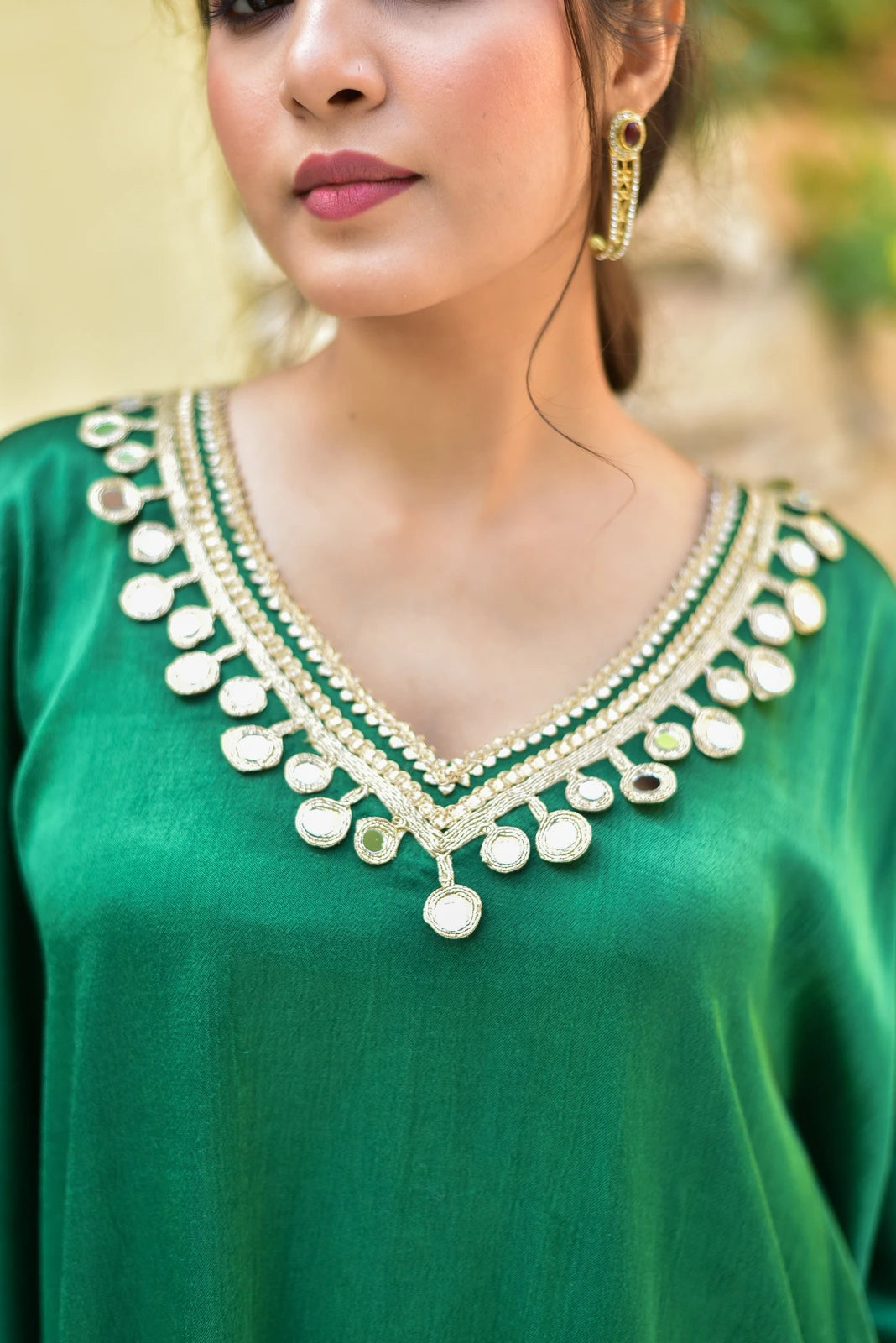 The Forest Glaze Mirror Work Set is a stunning ensemble that embodies elegance and sophistication. Crafted from luxurious Gazzi Satin, this exquisite kaftan set boasts a rich emerald hue reminiscent of the forest's depths. The intricate mirror work detailing adds a touch of regality, catching the light with every movement.
This ensemble is perfect for making a statement at any formal occasion, whether it's a wedding, a gala, or a special event.
