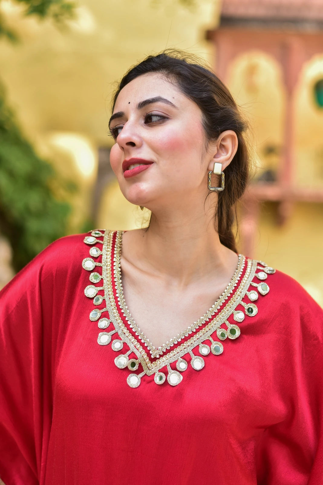 The Chili Glaze Mirror Work Set is a stunning ensemble crafted from luxurious Gazzi Satin fabric, showcasing a rich and vibrant chili glaze color. This elegant kaftan set features intricate mirror work detailing that adds a touch of sophistication and glamour to the overall design. The set is perfect for special occasions, such as weddings or formal events, and is sure to make a statement with its unique and eye-catching style.