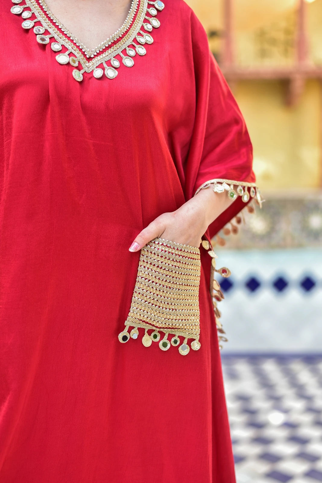 The Chili Glaze Mirror Kaftan Set is a stunning ensemble crafted from lustrous Gazzi Satin, exuding regal elegance and contemporary ease. The rich emerald color captures the essence of the forest, while the exquisite mirror work detailing adds a touch of sophistication. This set is perfect for those seeking a stylish and comfortable attire that makes a statement. With its luxurious fabric and intricate design, it's an ideal choice for special occasions or everyday wear.