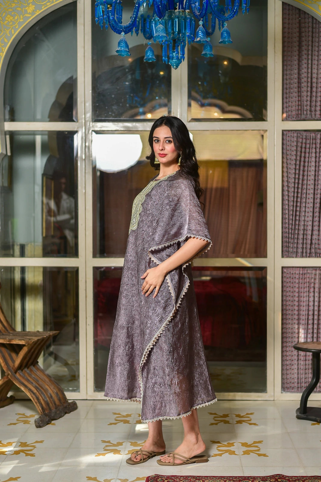 This elegant lavender kaftan dress exudes sophistication and luxury, crafted from premium moss organza that drapes beautifully while maintaining its structure. The sophisticated lavender hue adds a regal touch, making this piece a standout for special occasions. The kaftan's design features a stunning embroidered detail on the front, adding a touch of modernity and elegance. The dress is perfect for those seeking a stylish and comfortable outfit for formal events or as a statement piece for everyday wear.