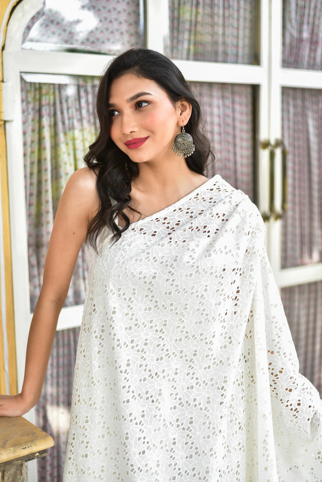 The Black Majesty Cape Dress is a stunning two-piece ensemble that exudes elegance and sophistication. The sleek 100% cotton dress is paired with an exquisite hacuba cape adorned with intricate laser-cut floral patterns, creating a truly unique and eye-catching look. The dress features a comfortable and flattering fit, while the cape adds a touch of drama and flair to the overall design.