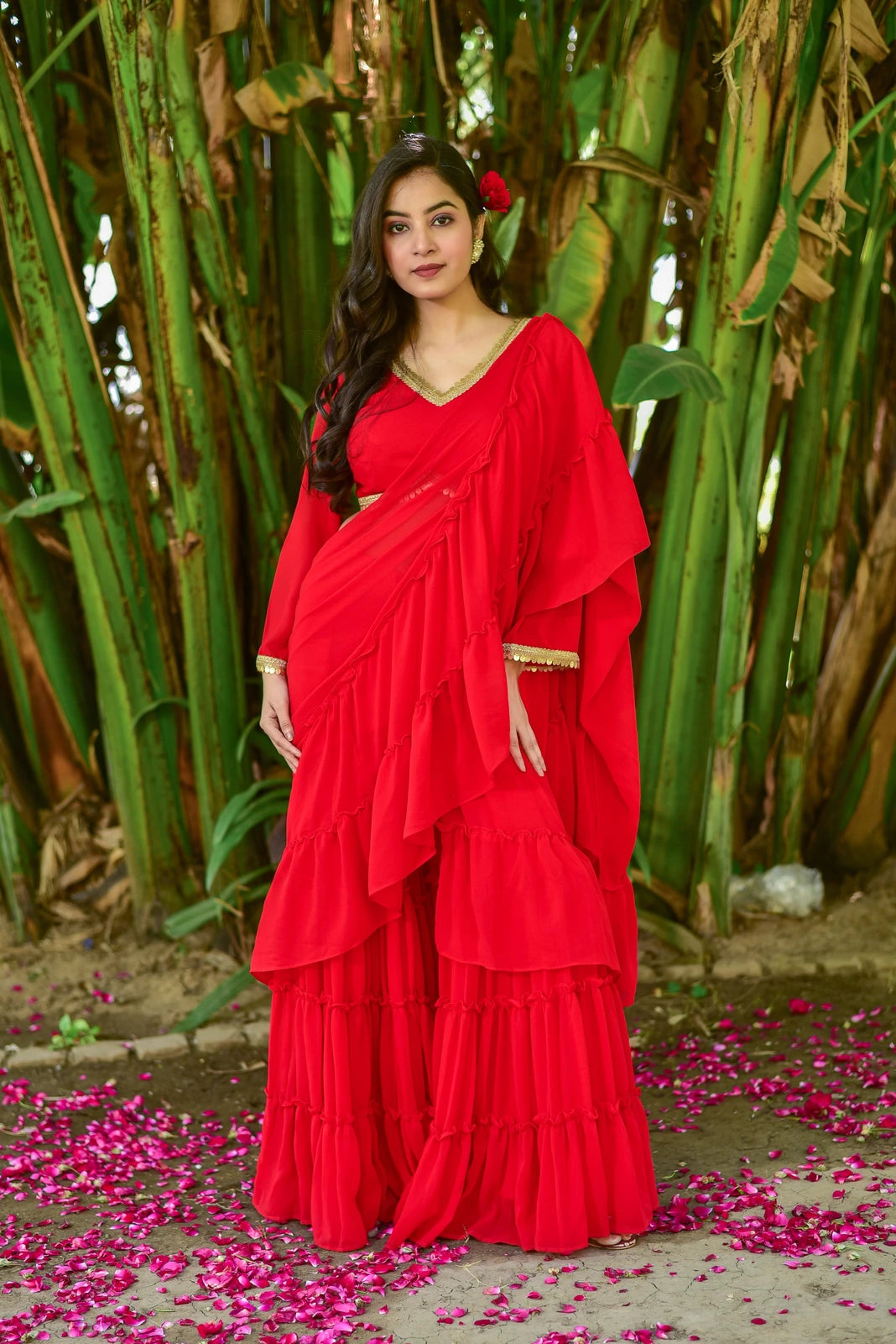 The Regal Red Georgette Sharara Set is a stunning fusion of traditional grace and contemporary design, perfect for making a statement at weddings, festive celebrations, and special occasions. This exquisite ensemble features a regal red georgette fabric, exuding elegance and sophistication. The set includes a sharara, a traditional Indian garment with a flowing, wide-legged pant, paired with a matching blouse and a beautiful georgette dupatta.