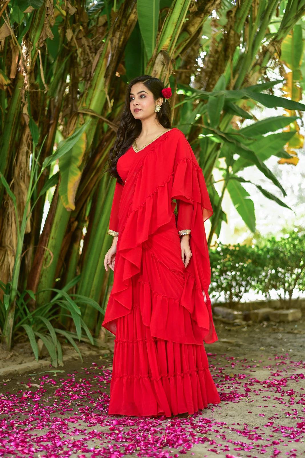 The Regal Red Georgette Sharara Saree Set is a stunning fusion of traditional grace and contemporary design, perfect for weddings, festive celebrations, and special occasions. This exquisite ensemble features a vibrant red georgette fabric, elegant sharara style, and a delicate red rose hair accessory, creating a captivating look that exudes elegance and sophistication. With its high-quality construction and attention to detail, this set is sure to make a statement and leave a lasting impression.
