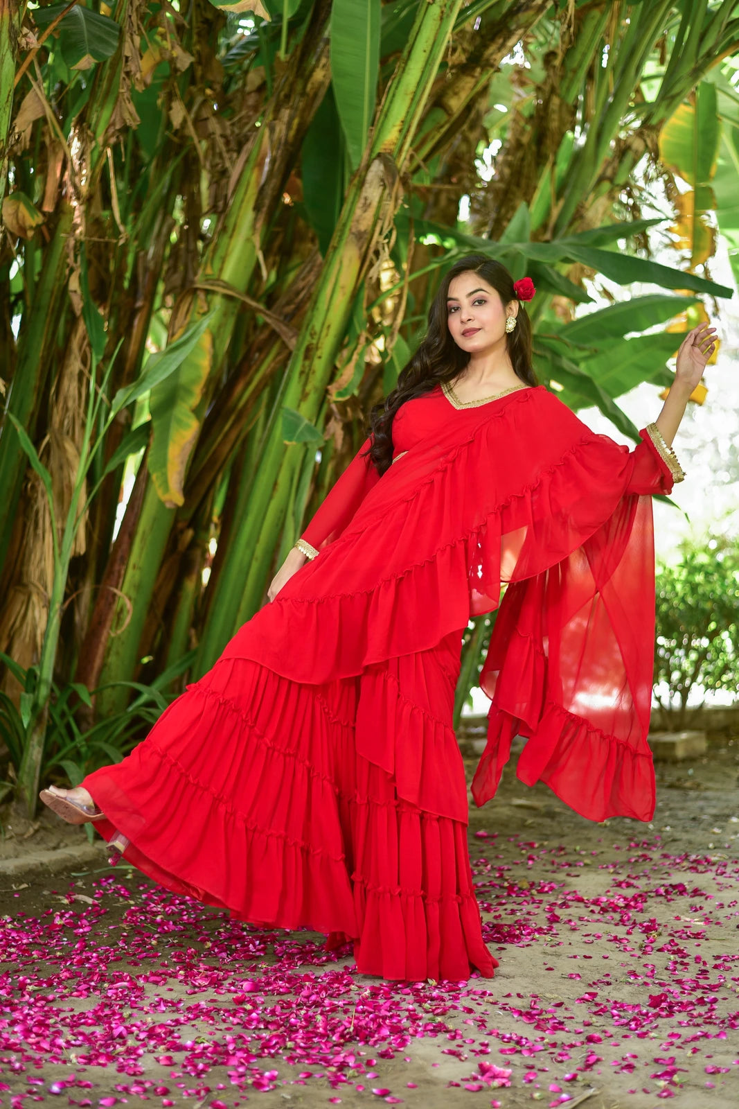 The Regal Red Georgette Sharara Set is a stunning fusion of traditional grace and contemporary design, perfect for weddings, festive celebrations, and special occasions. This exquisite ensemble features a vibrant red georgette fabric, adorned with intricate embroidery and embellishments that add a touch of elegance to the overall look. The sharara-style pants are loose-fitting and flowy, creating a dramatic effect as you move.