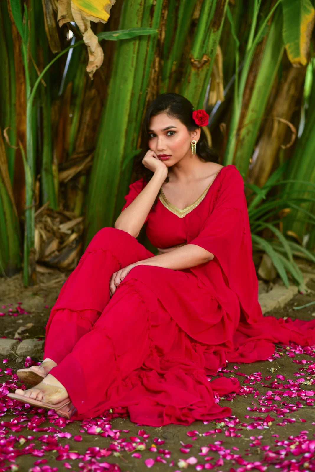 The Ruby Pink Georgette Sharara Set is a stunning fusion of traditional grace and contemporary design, perfect for weddings, festive celebrations, and special occasions. This exquisite ensemble features a vibrant ruby pink color, flowing georgette fabric, and a stylish sharara silhouette that exudes elegance and sophistication. The set includes a matching blouse with intricate embroidery and a flowing sharara pant, complete with a delicate border and a dramatic train.