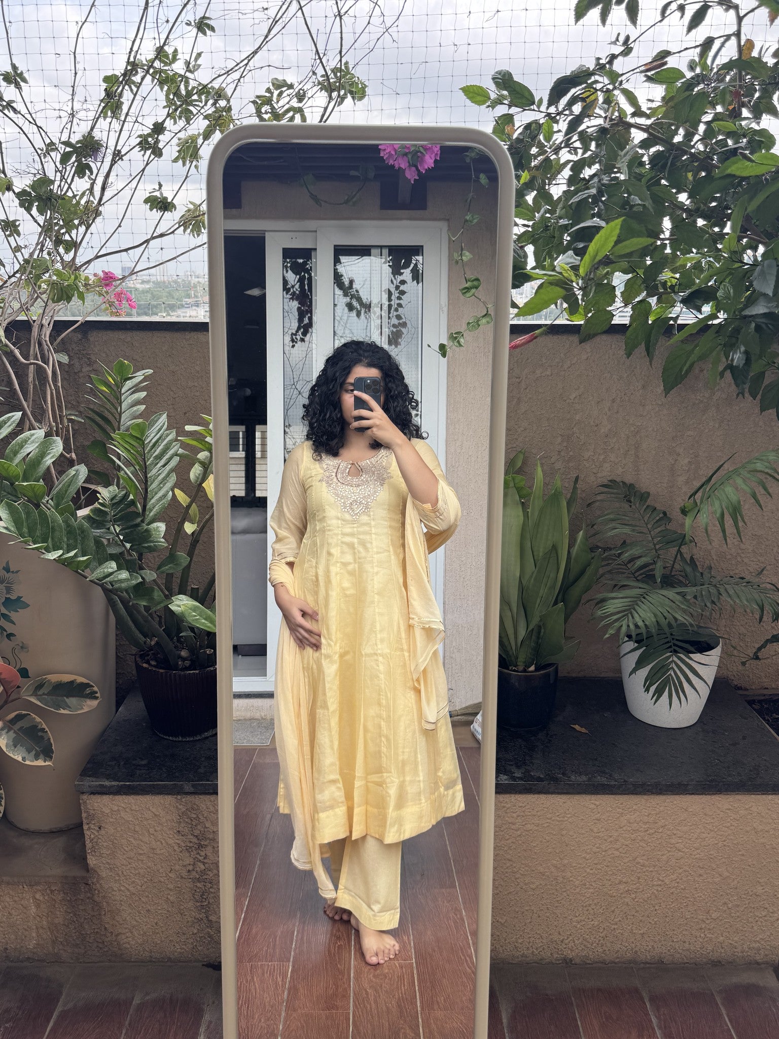Saroj Jain Pastel Sunshine Yellow Lucknowi Chikankari Anarkali Gown front mirror view showing keyhole neckband and embroidered yoke.