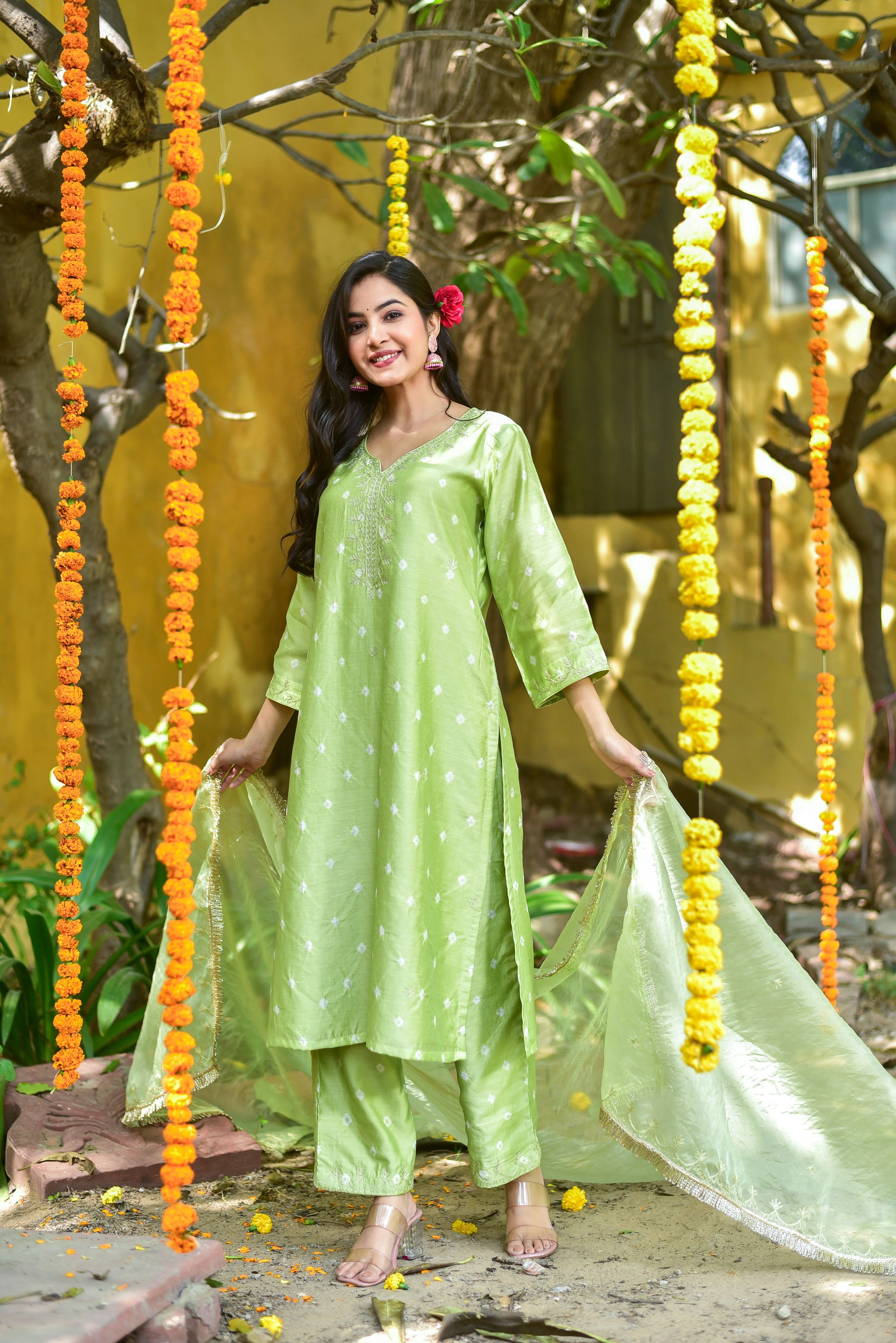 The Green Bandhej A-Line Kurta Set is a stunning and elegant ensemble that exudes traditional charm and sophistication. This exquisite piece features a vibrant green hue with intricate bandhej tie-dye artistry, creating a unique and eye-catching look. The A-line silhouette of the kurta adds a touch of modernity, while the matching pants and dupatta complete the set, creating a cohesive and stylish outfit.