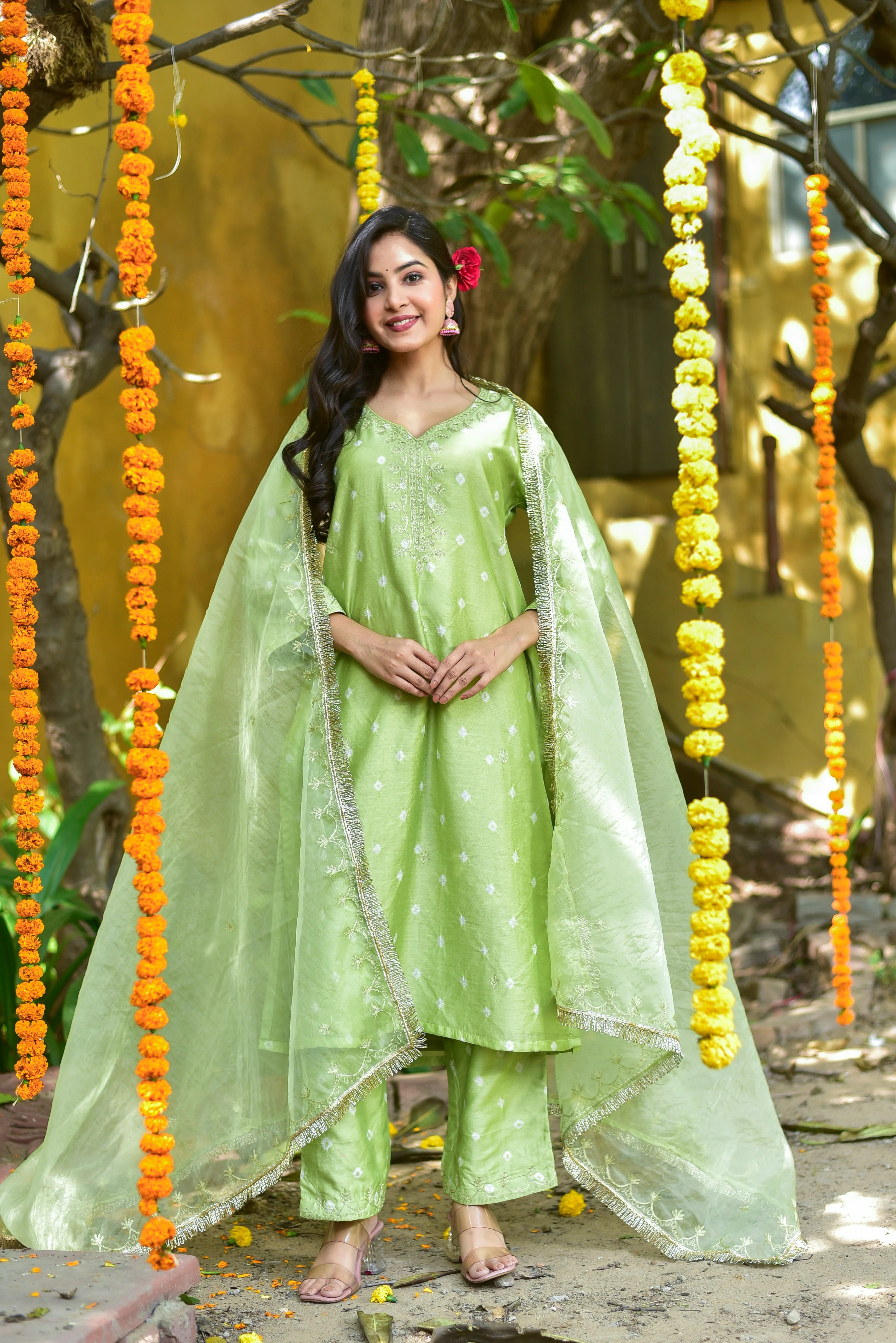 The Green Bandhej A-Line Kurta Set is a stunning piece of traditional Indian attire that exudes elegance and sophistication. This exquisite ensemble features a vibrant mint-green hue, adorned with intricate bandhej tie-dye patterns that add a touch of cultural charm. The A-line silhouette of the kurta creates a flattering and feminine look, while the matching pants and dupatta complete the set, creating a cohesive and stylish outfit.