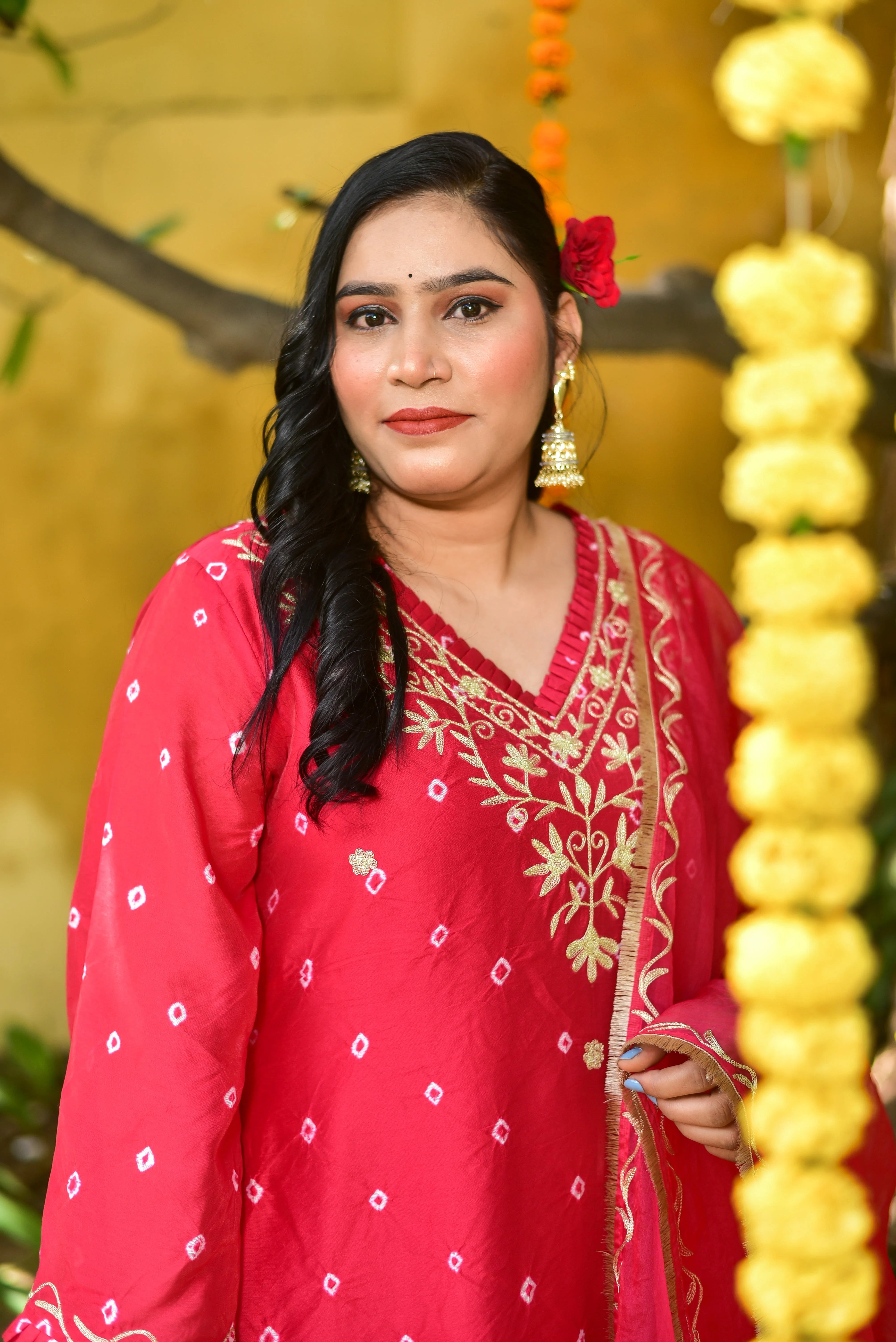 The red Bandhej asymmetrical kurta set is a stunning ensemble that combines traditional tie-dye artistry with modern silhouette sophistication. The hand-crafted design features intricate details and a vibrant red color, making it perfect for festive celebrations. The asymmetrical kurta adds a touch of elegance and sophistication, while the matching pant set completes the look. This exquisite piece is sure to turn heads and make a statement at any occasion.