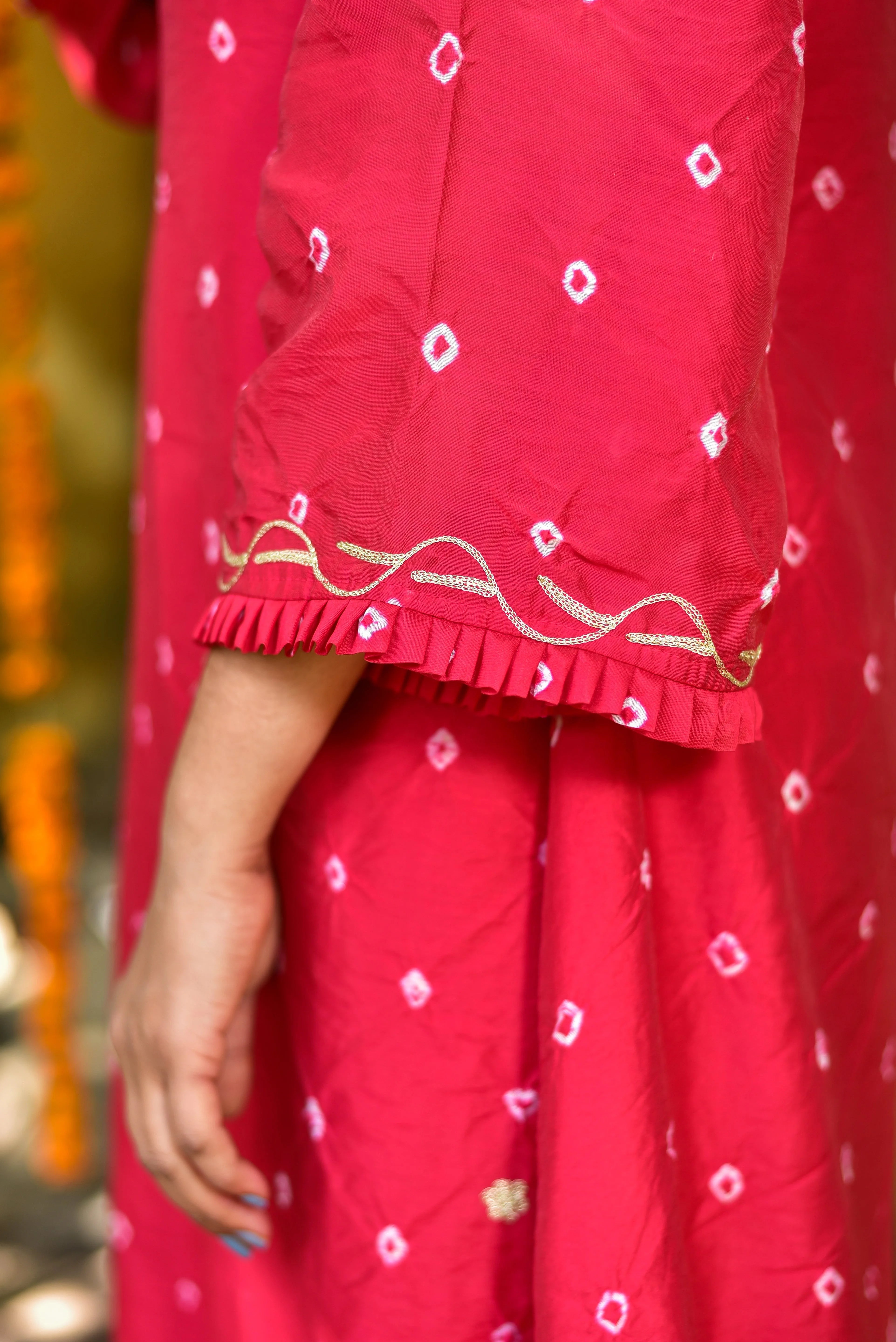 This stunning red Bandhej asymmetrical kurta set is a true masterpiece of traditional Indian craftsmanship, expertly blended with modern design elements. The intricate tie-dye artistry on the fabric creates a visually striking pattern that adds a touch of elegance to any outfit. The asymmetrical silhouette gives the garment a contemporary twist, making it perfect for those who want to stand out from the crowd.
