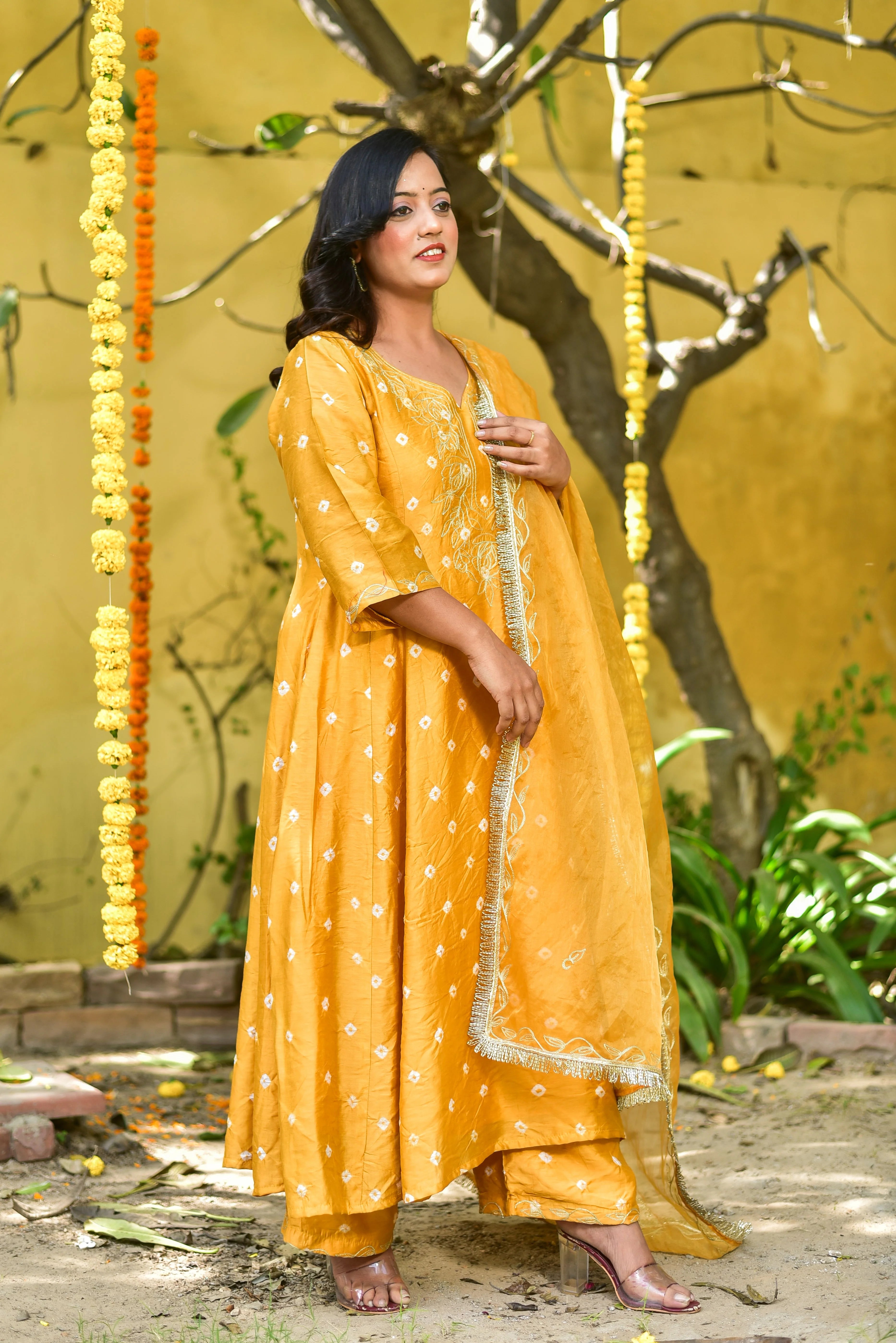 Elevate Your Style with the Mustard Yellow Bhandej Kurta Set

This stunning ensemble is a testament to traditional bandhani craftsmanship, exuding elegance and sophistication. The vibrant mustard yellow hue, reminiscent of sunshine, adds a pop of color to any occasion, making it perfect for auspicious events.