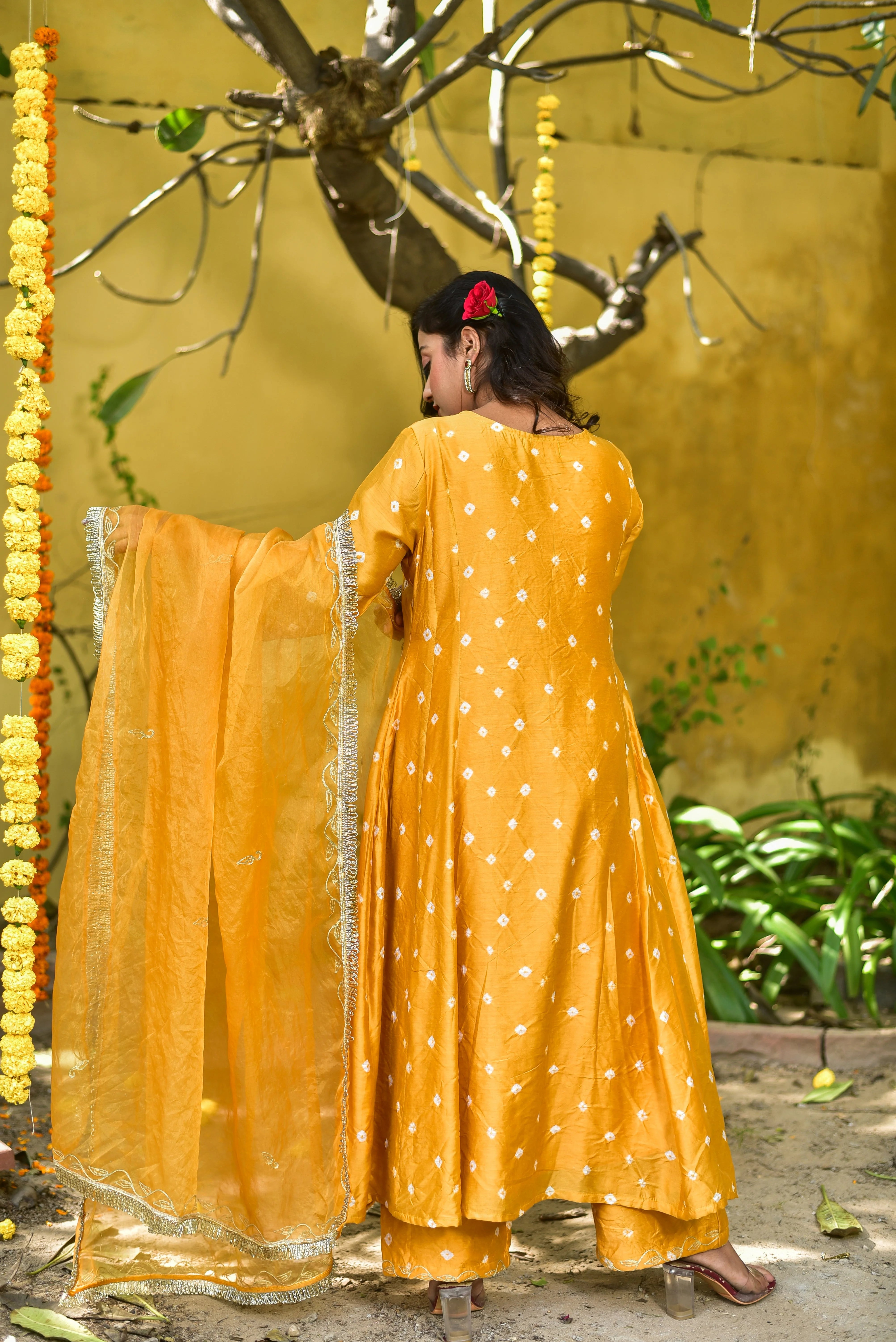 The Mustard Yellow Bhandej Kurta Set is a stunning ensemble that exudes elegance and tradition. The vibrant mustard yellow hue, reminiscent of sunshine, is adorned with intricate white bandhani patterns, adding a touch of sophistication to the overall design. Crafted from luxurious silk fabric, the kurta and pant set offers a comfortable and stylish fit, perfect for making a statement at any occasion.