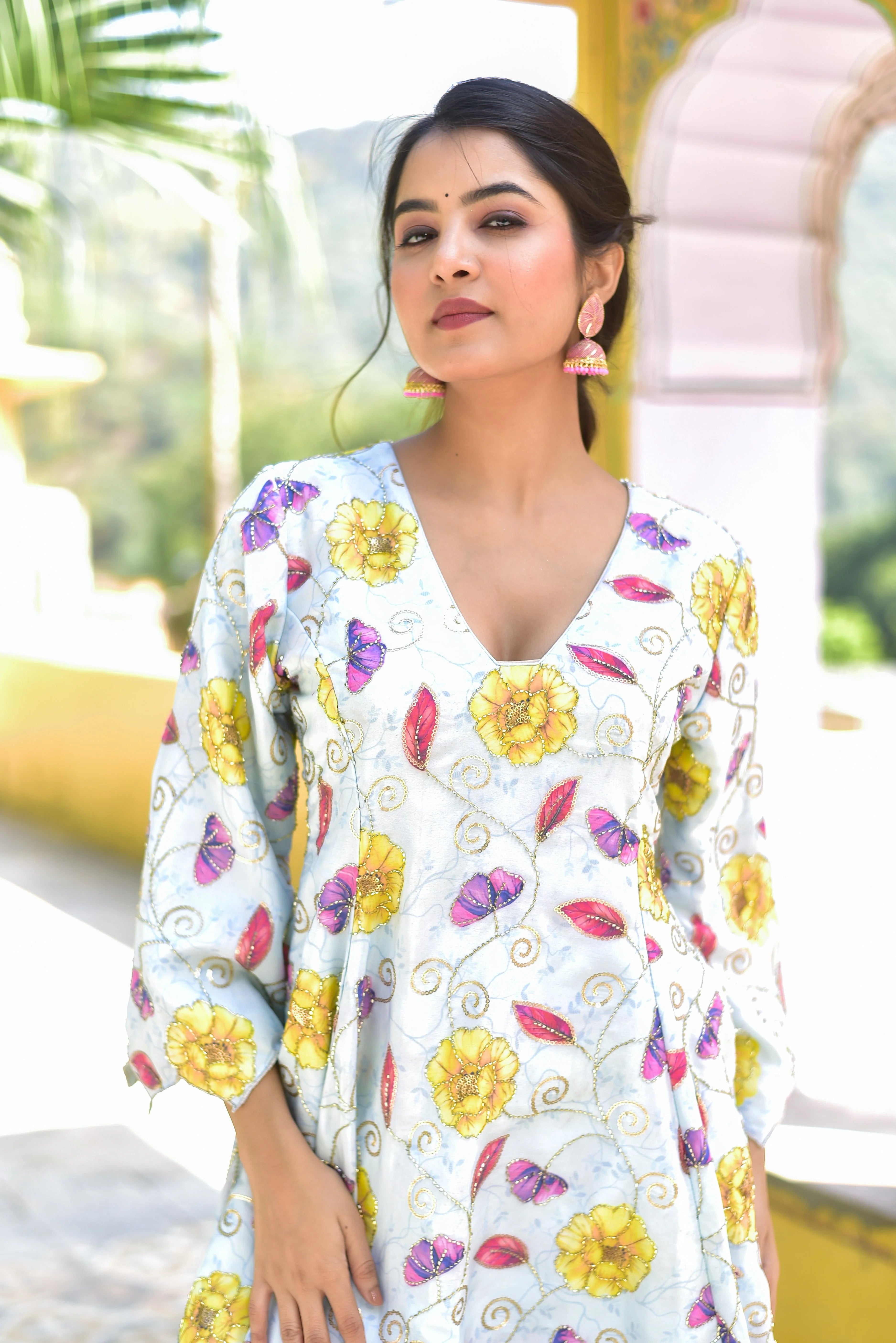 The Blue Morning Mist Floral Kurta Set is a captivating ensemble that embodies the essence of a serene garden on a misty morning. The soft blue and white hues of the fabric provide a tranquil backdrop for the vibrant floral print, which features a variety of colorful blooms and leaves. The intricate embroidery and delicate sequins add a touch of elegance and sophistication, making this kurta set perfect for any occasion.