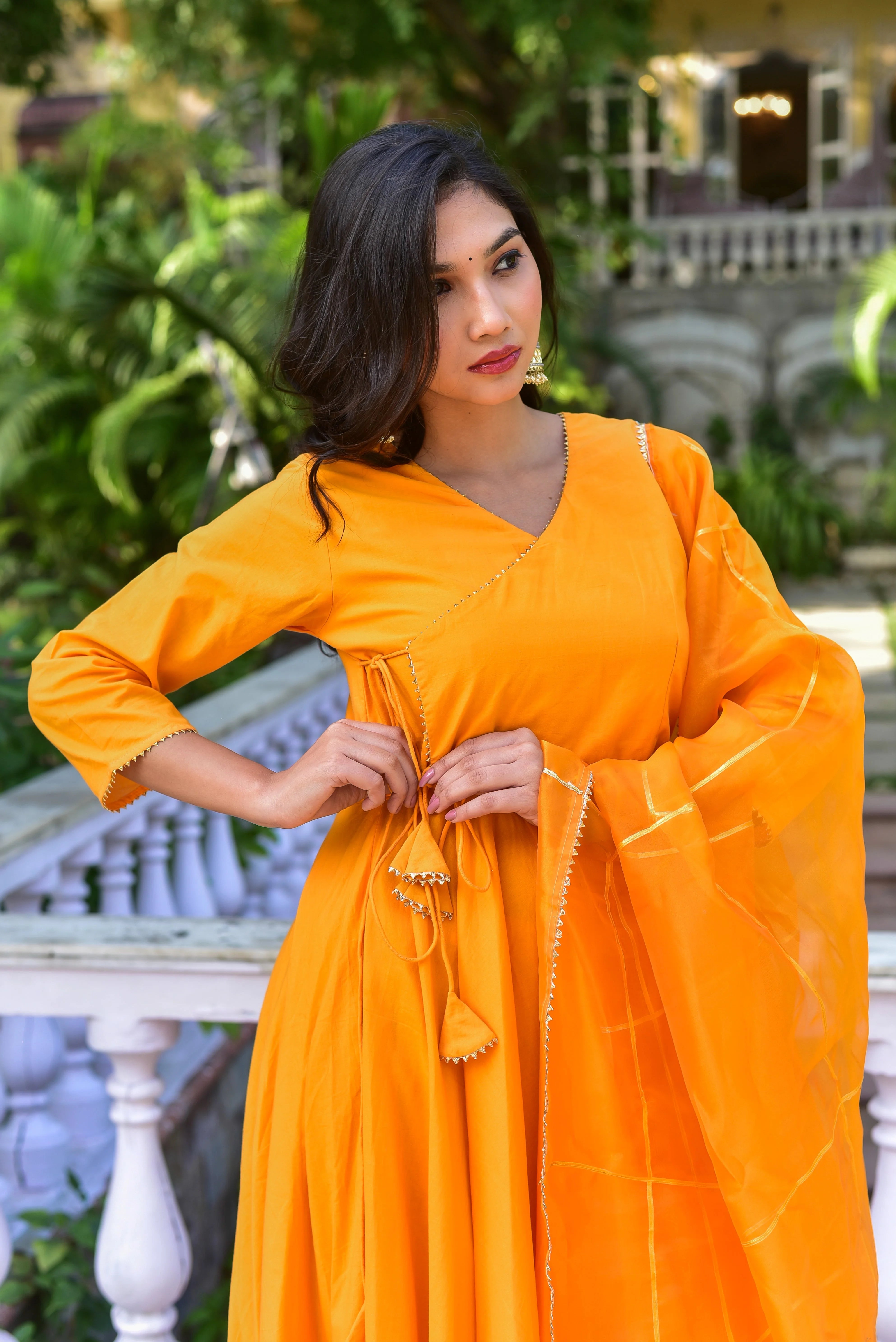 The Haldi Yellow Angrakha Anarkali Set: A Timeless Fusion of Tradition and Style

This exquisite ensemble, crafted from luxurious fabrics, embodies the essence of Holi celebrations. The vibrant Haldi Yellow hue exudes joy and festivity, while the intricate detailing adds a touch of elegance. The Angrakha style, with its traditional flair, is perfectly complemented by the flowing Anarkali silhouette.