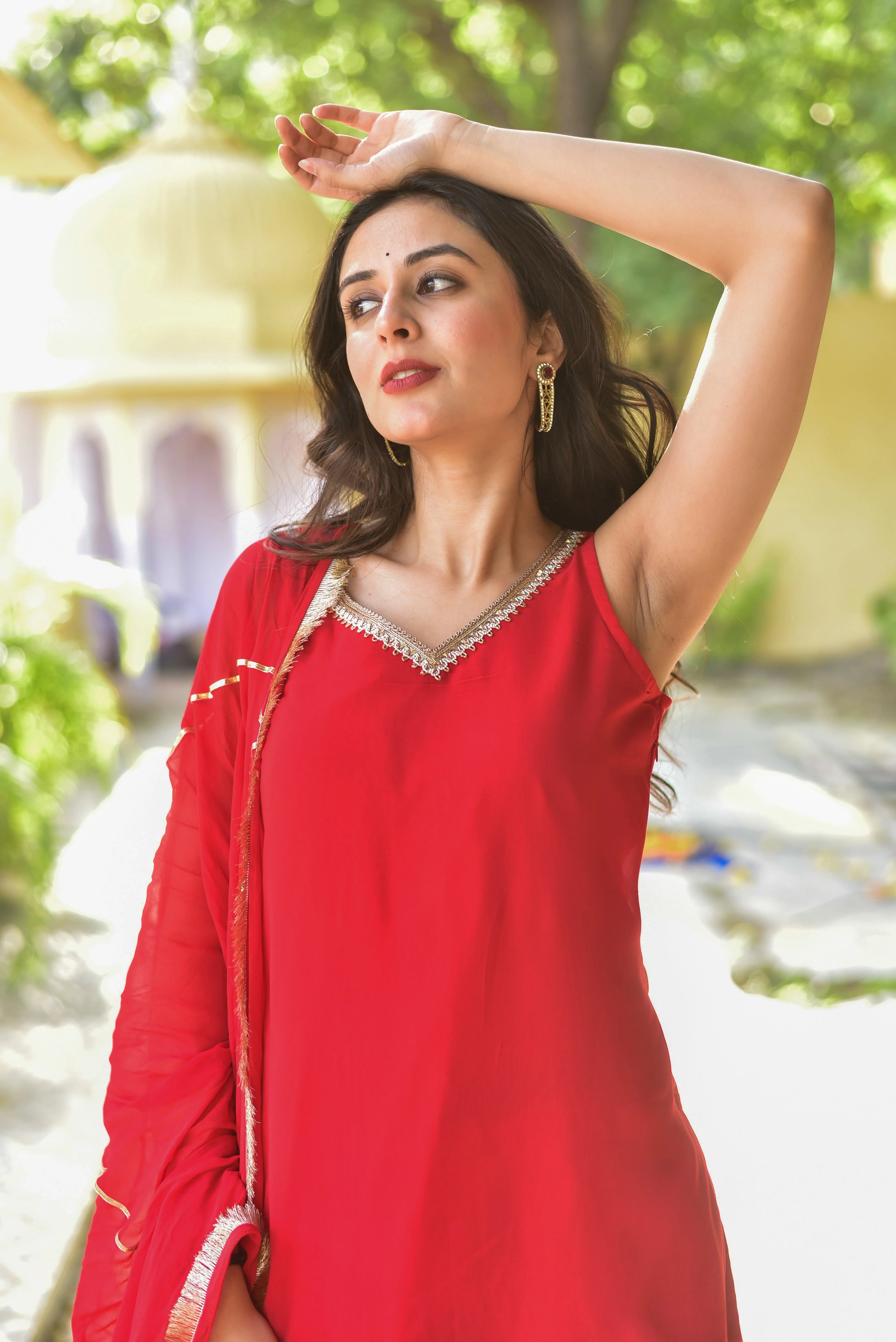 The Hot Red Gotta Kurta & Sharara Set is a stunning ensemble that combines traditional craftsmanship with contemporary elegance. Crafted from luxurious georgette fabric, this outfit drapes beautifully and moves with effortless grace.

This exquisite set features intricate gotta work that adds a touch of sophistication and glamour to the overall design.