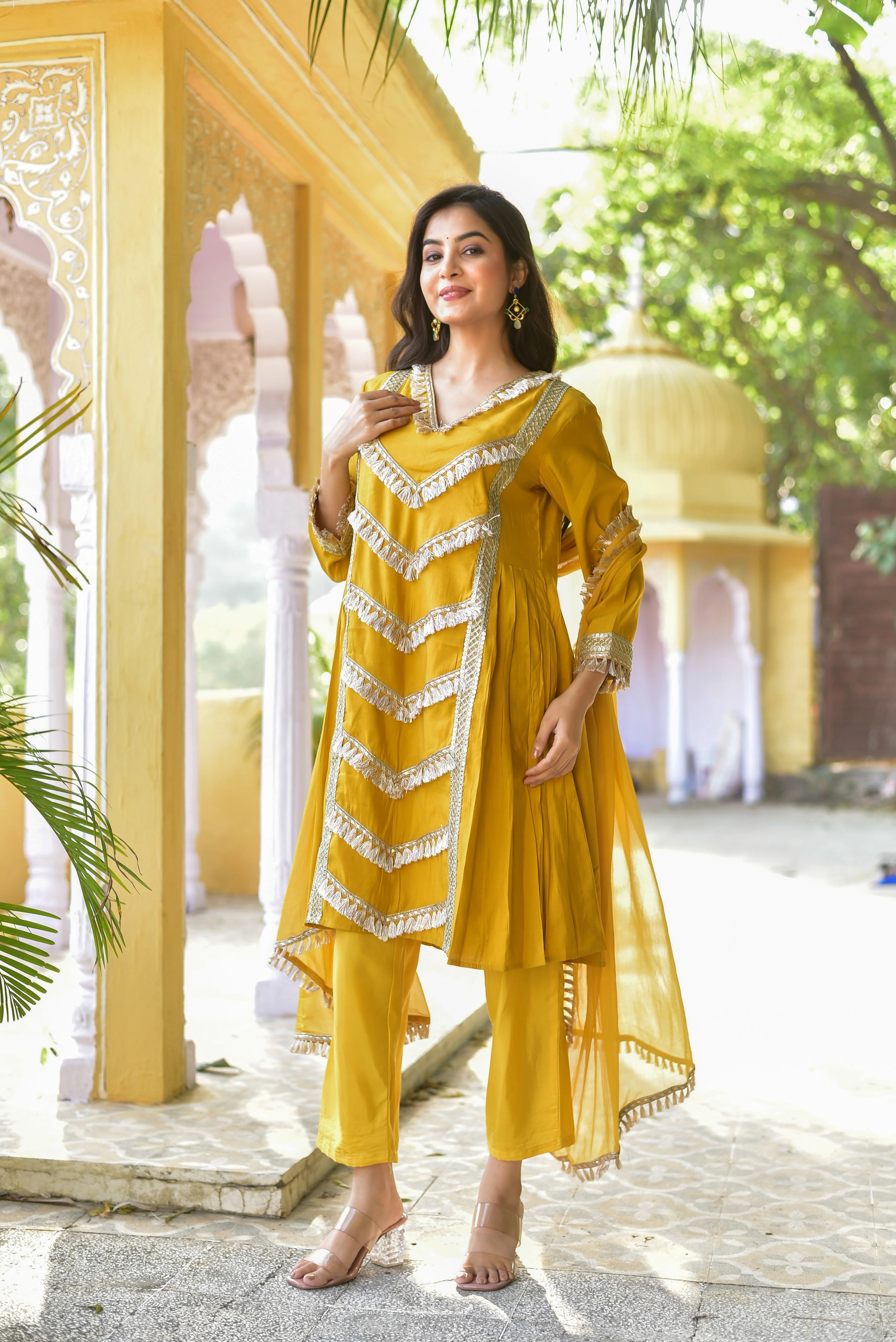 The Yellow Gold Kurta & Pant Set: A Fusion of Tradition and Contemporary Elegance

This stunning ensemble, crafted from luxurious yellow gold fabric, embodies the perfect blend of tradition and modern style. The intricate detailing, including a high-low hemline and long sleeves, adds a touch of sophistication, while the elegant V-neckline and straight-cut pant create a flattering silhouette.