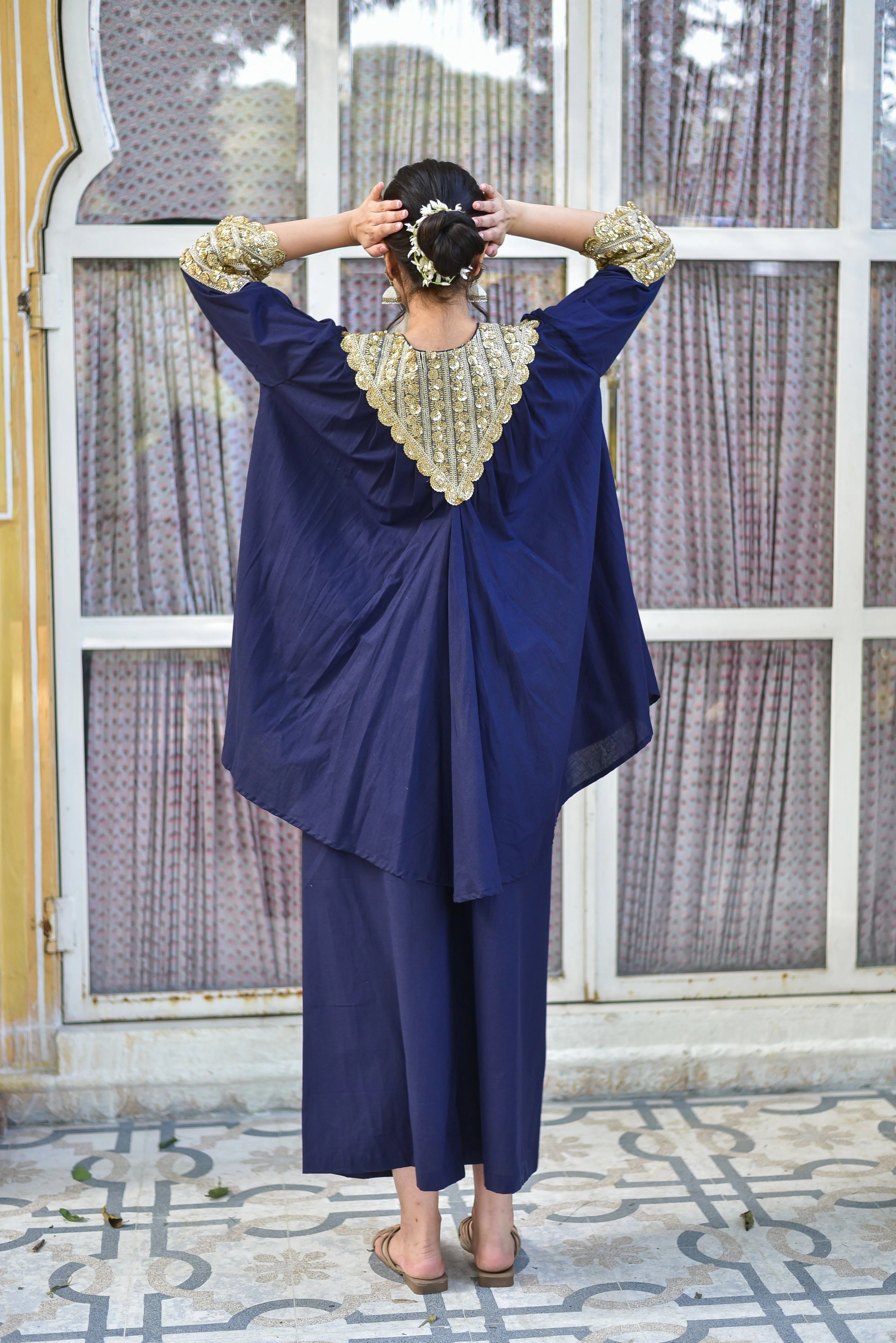 The Blueberry Gold Glaze Co-Ord Set is a masterpiece of elegance, featuring a rich blue hue and luxurious gold accents that exude sophistication. Crafted from 100% pure cotton, this ensemble drapes beautifully, ensuring all-day comfort and breathability. The intricate gold embroidery adds a touch of refinement, making it perfect for formal occasions or everyday wear. With its timeless design and high-quality materials, this set is sure to make a statement.