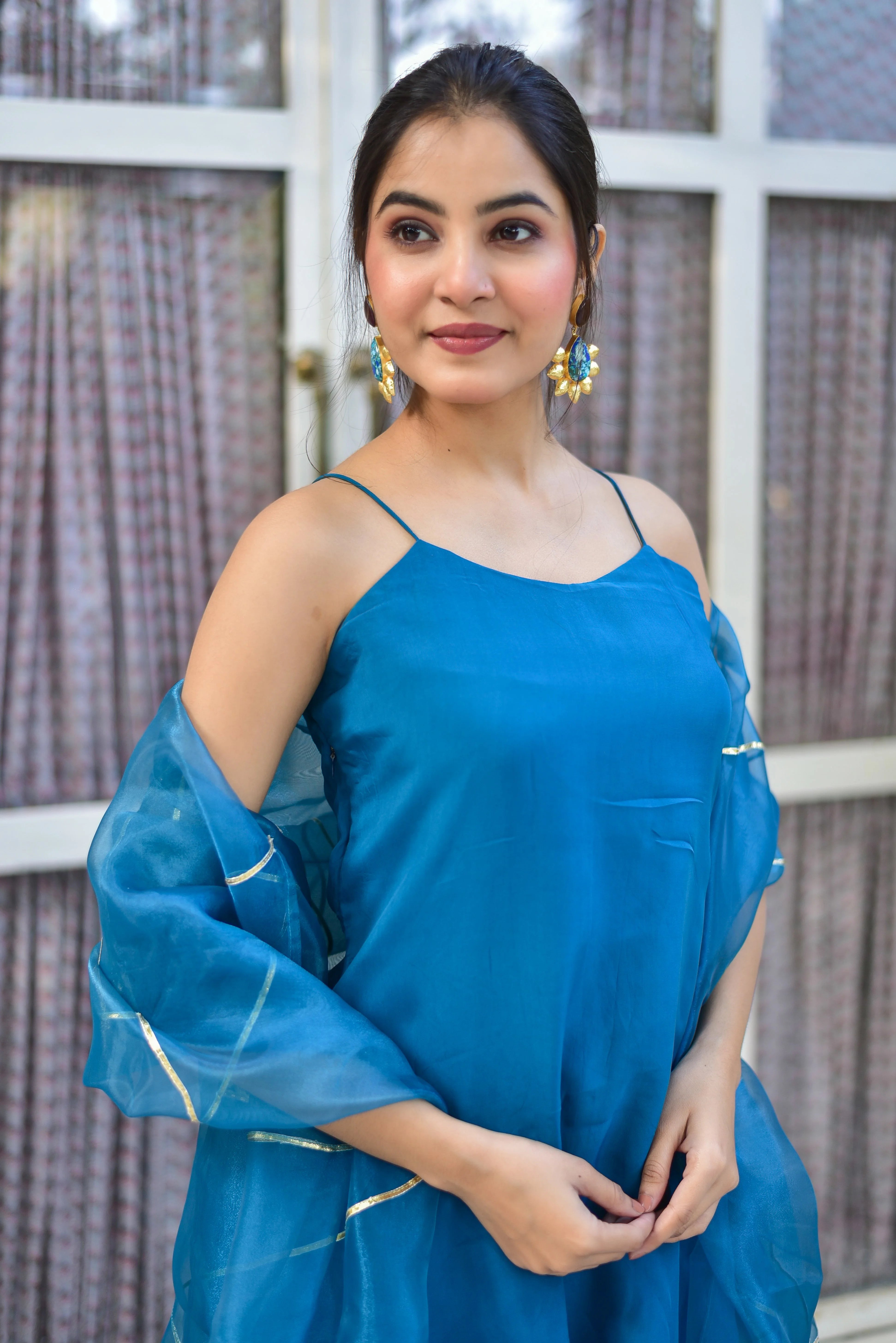 The Teal Blue Kurta Sharara Set is a stunning ensemble that embodies elegance and sophistication. This exquisite piece is crafted with attention to detail, featuring intricate embroidery and a rich teal blue hue that exudes refinement. The kurta boasts a classic silhouette, complemented by a matching sharara that adds a touch of modernity to the traditional design. The set is completed with a delicate dupatta, adding a layer of texture and visual interest.