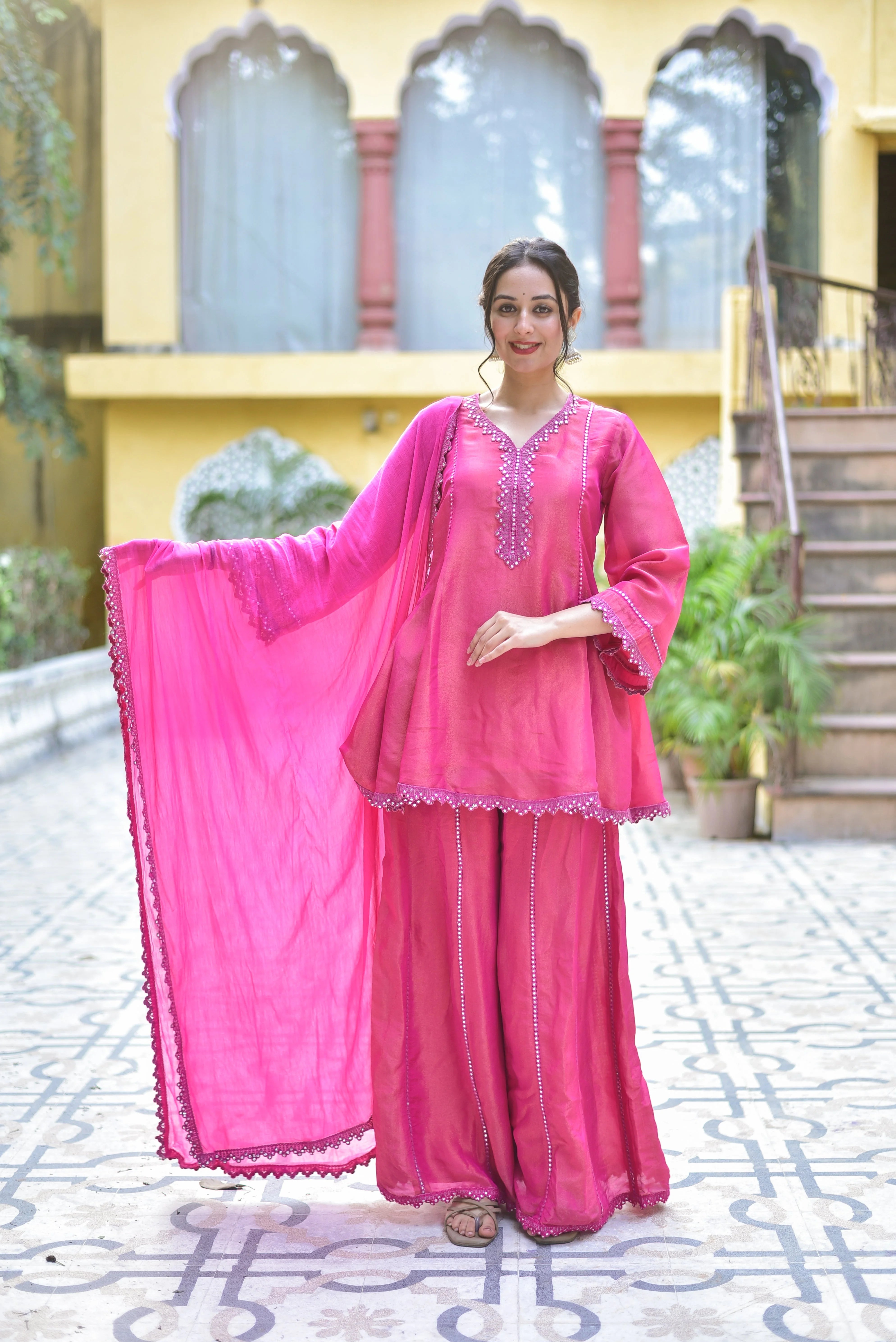The Pink Zari Silk Kurta Sharara Set is a stunning ensemble that exudes elegance and sophistication. The vibrant pink hue of the kurta and sharara is accentuated by intricate zari embroidery, adding a touch of luxury to this traditional Indian attire. Crafted from high-quality silk, this set is both comfortable and durable, making it perfect for special occasions and festive celebrations.
