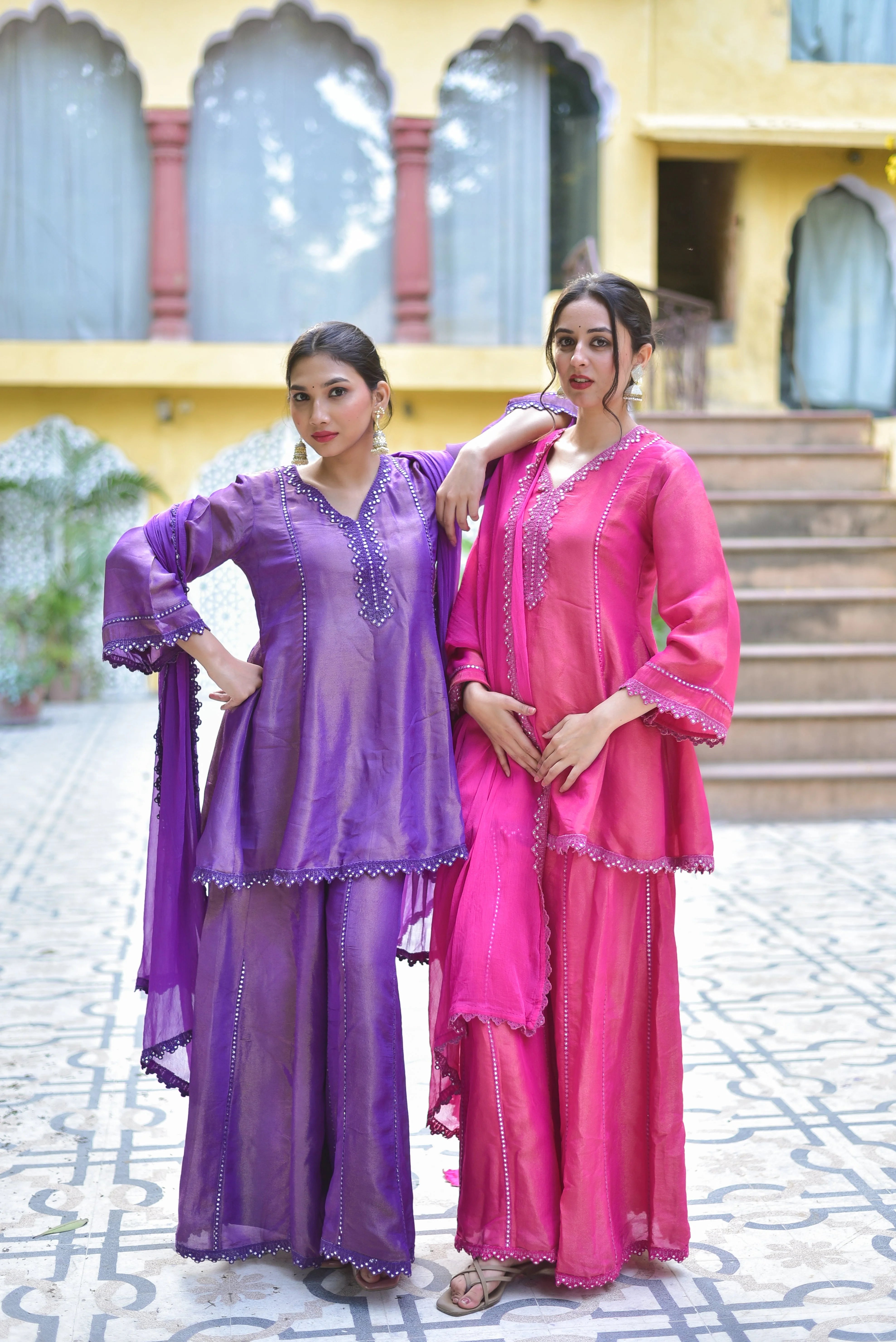 The Purple Zari Silk Kurta Sharara Set is a masterpiece of traditional craftsmanship and contemporary elegance. This exquisite ensemble features a rich purple hue, crafted from luxurious zari silk fabric that exudes opulence and sophistication. The intricate zari work adorning the kurta and sharara adds a touch of regal luxury, making it perfect for festive occasions and special gatherings.