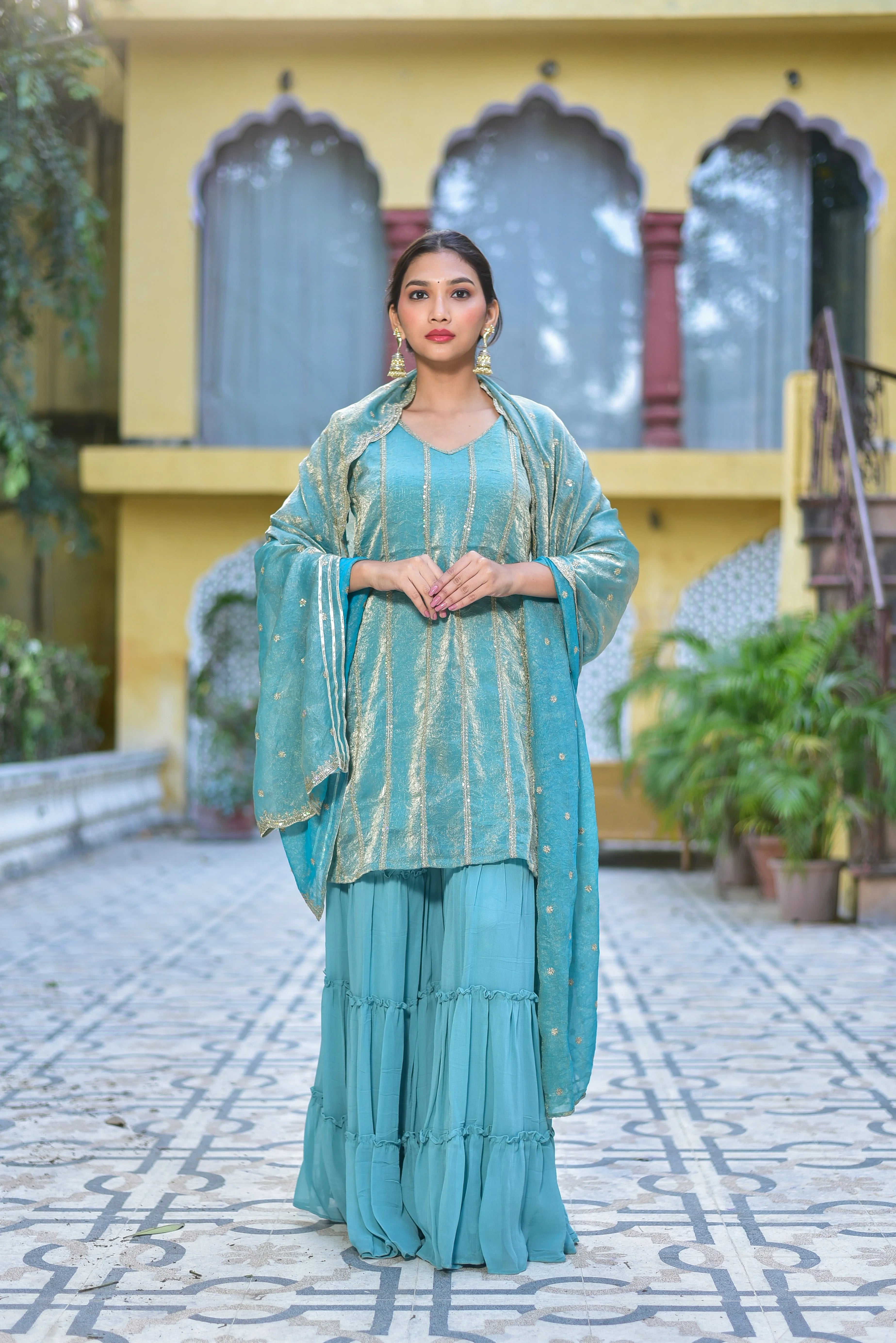 The Sea Green Kurta Sharara Set is a stunning ensemble that embodies elegance and sophistication. This exquisite piece features a sea green kurta with intricate gold accents, complemented by a matching sharara and dupatta. The fabric is luxurious and comfortable, making it perfect for special occasions and everyday wear. The set is designed to flatter any body type, with a tailored fit and flowing silhouette that exudes grace and poise.