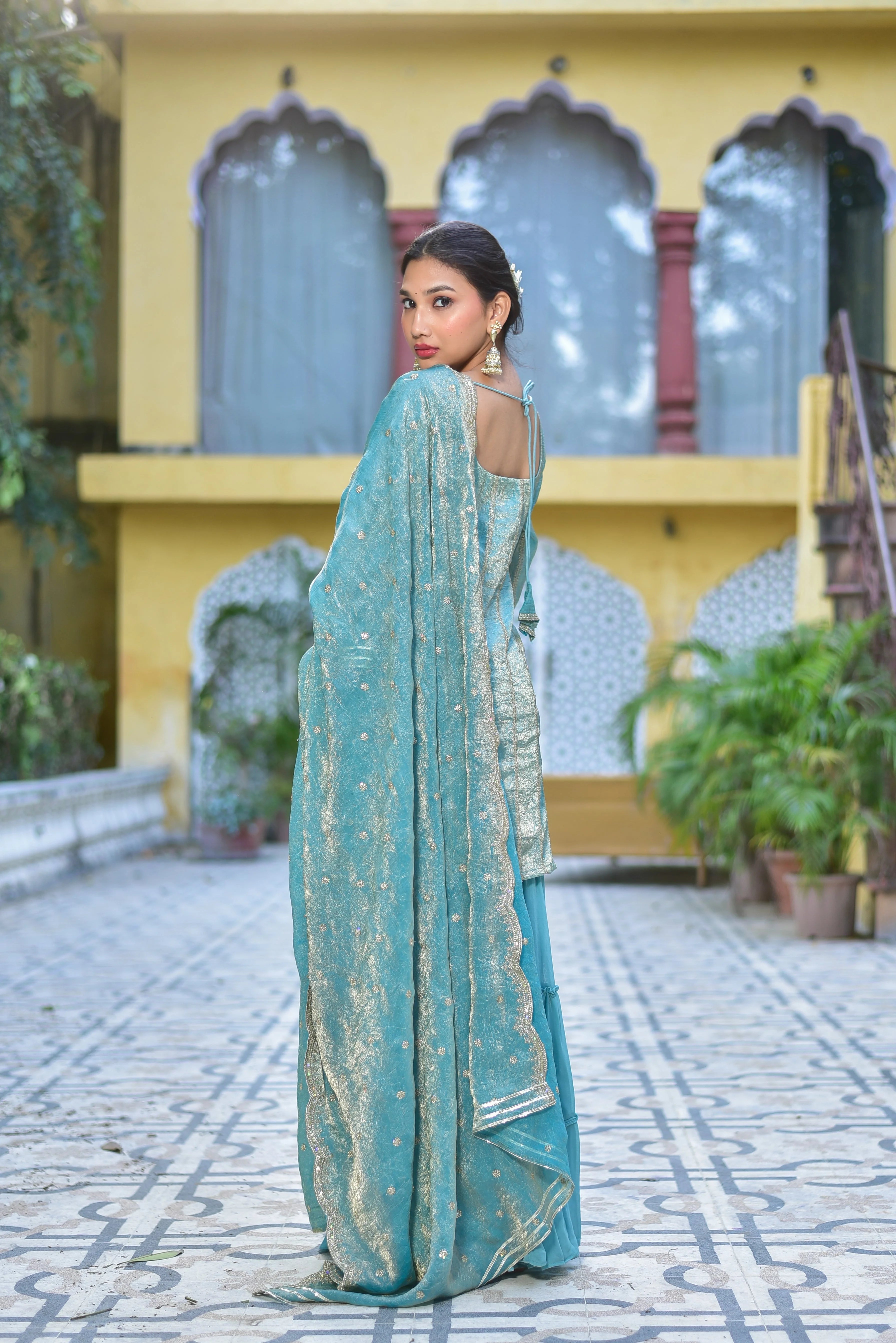 The Sea Green Kurta Sharara Set is a stunning ensemble that exudes elegance and sophistication. The sea green color of the kurta and sharara adds a touch of freshness and vibrancy to the overall look, while the intricate embroidery and patterns on the fabric create a sense of luxury and refinement. The kurta features a classic design with a round neckline and long sleeves, while the sharara pants are loose-fitting and flowy, creating a comfortable and relaxed silhouette.