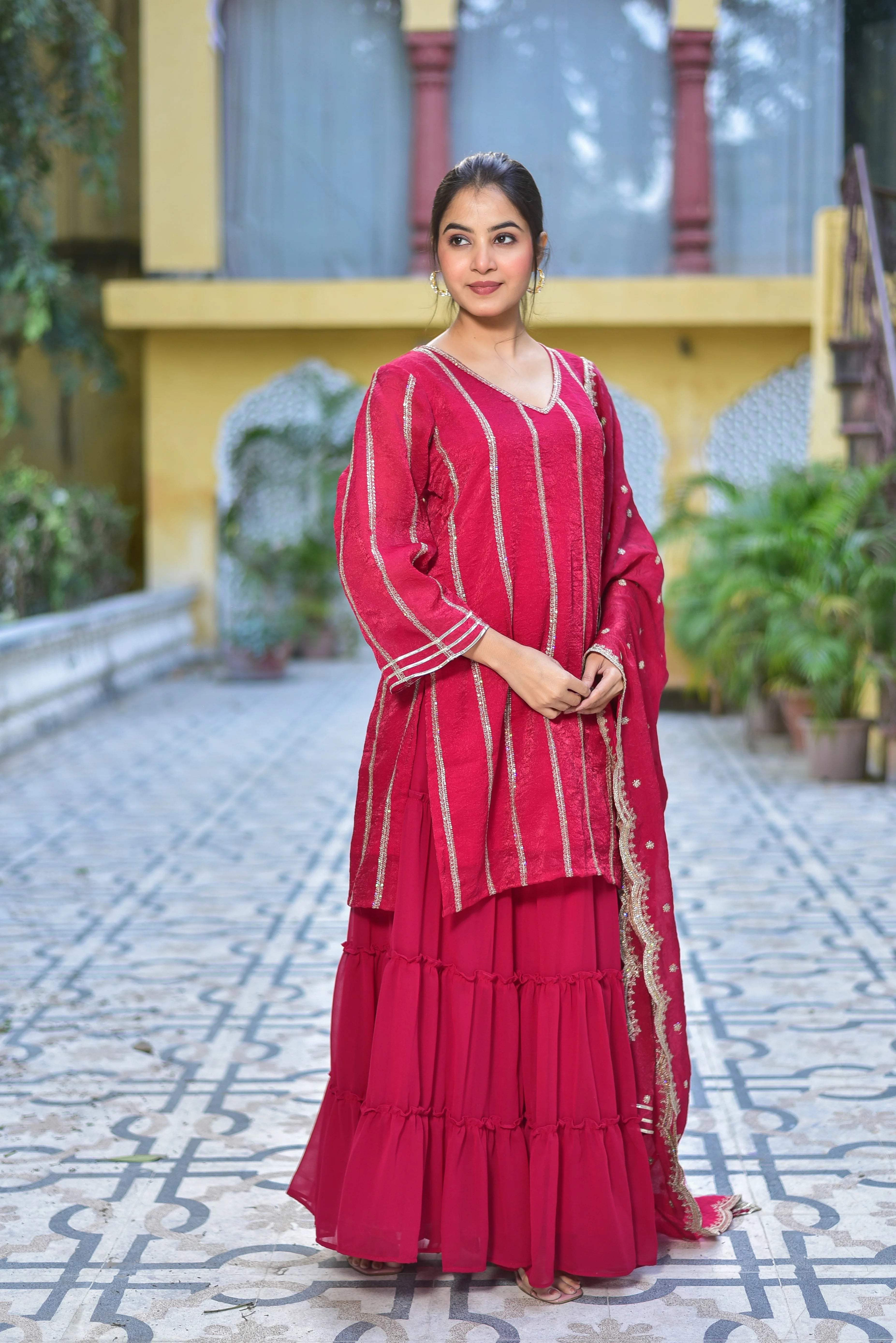 The Magenta Heavy Sharara Set is a stunning ensemble that exudes elegance and sophistication. The vibrant magenta color is a true showstopper, while the intricate embroidery and heavy fabric add a touch of luxury to this traditional Indian outfit. Perfect for special occasions and celebrations, this set is sure to make a statement. With its elegant design and comfortable fit, it's a must-have for any fashion-forward individual.
