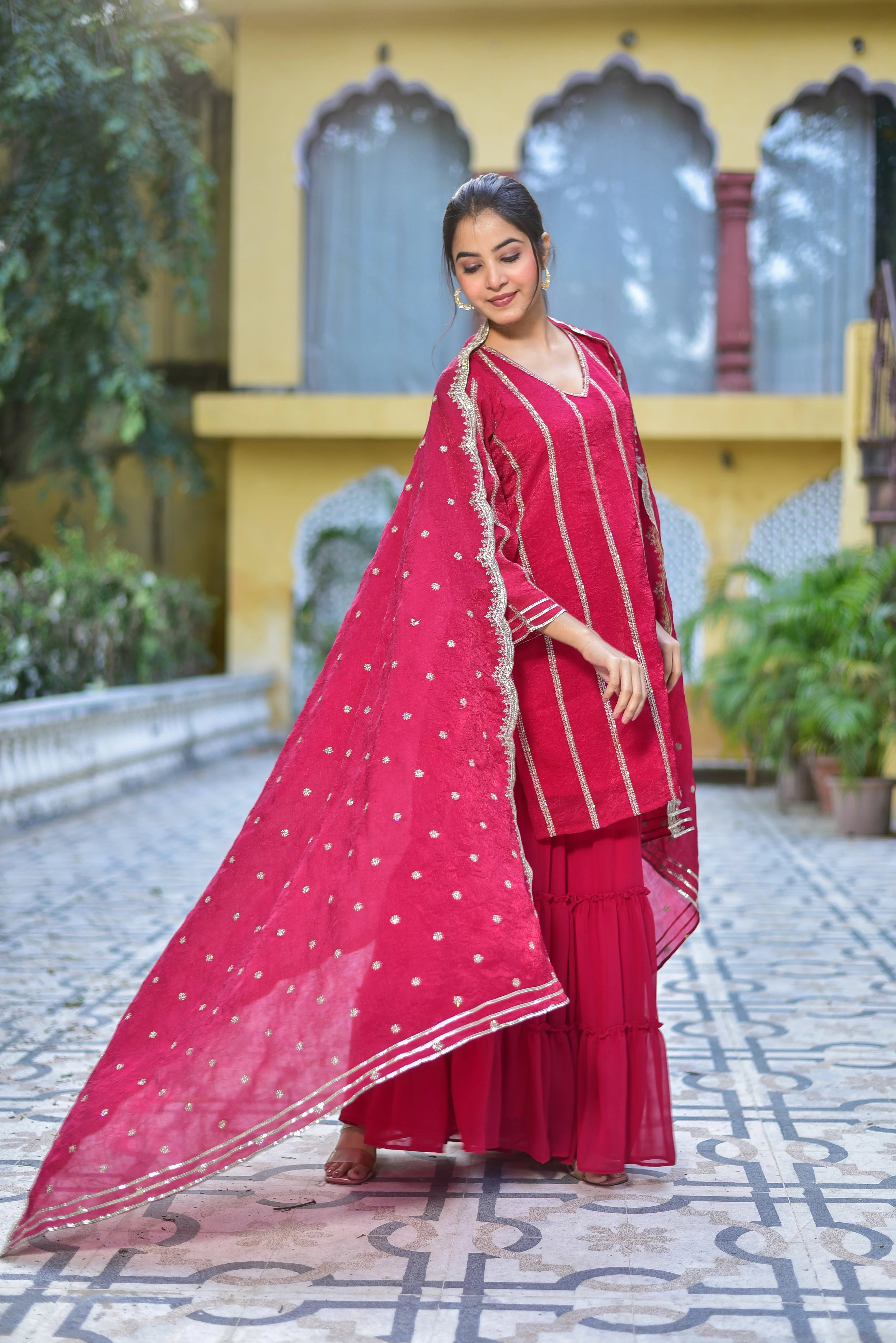 The Magenta Heavy Sharara Set: A Regal Ensemble for Festive Elegance

This stunning sharara set is a masterpiece of artisanal craftsmanship, perfect for festive occasions and special gatherings. The rich magenta hue and intricate design elements evoke a sense of timeless elegance, making it a standout piece for any woman who appreciates the finer details.