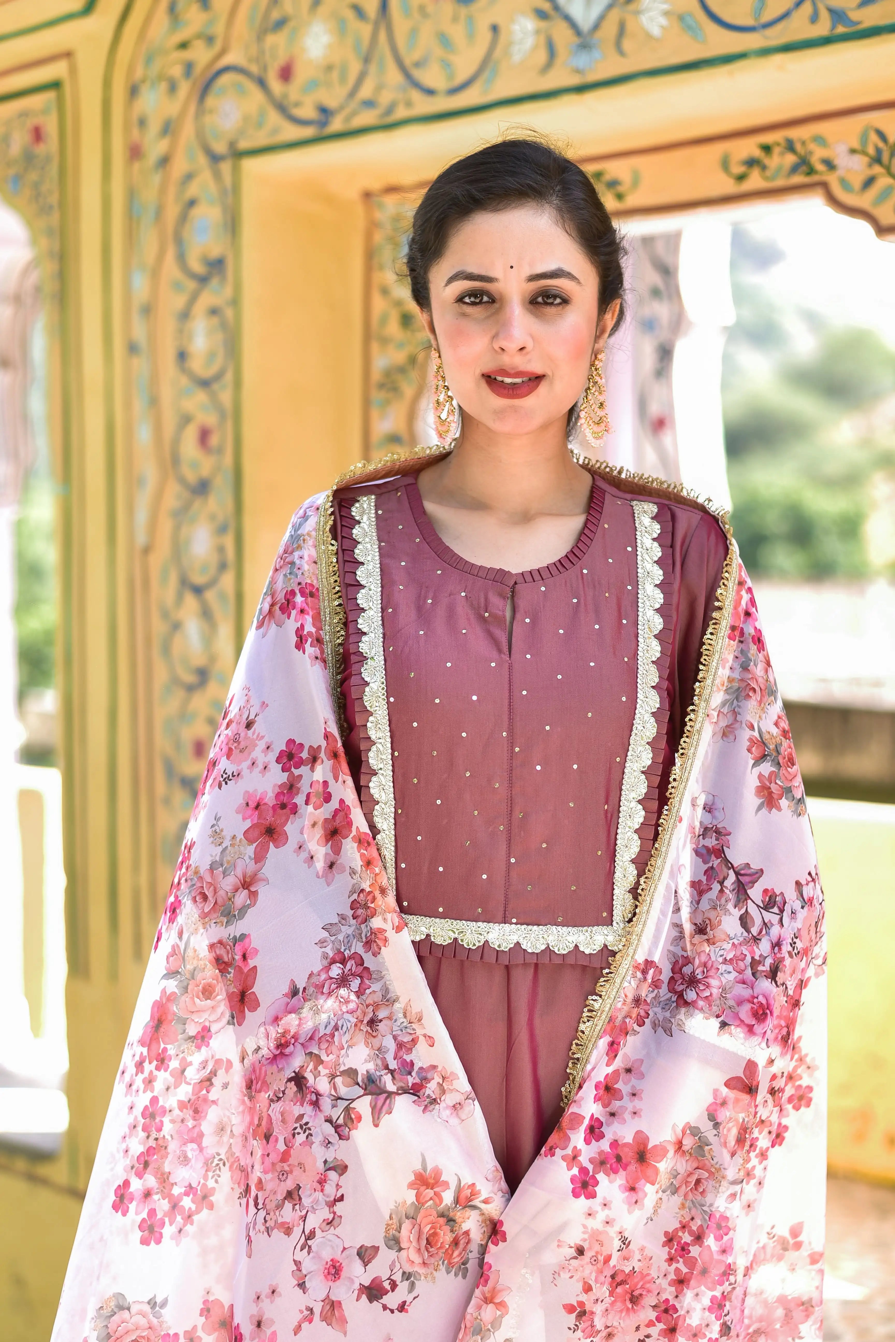 The Onion Pink Kurta & Pant Set is a stunning ensemble that exudes elegance and sophistication. The rich peacock blue color of the kurta and pant is elevated by an exquisite floral dupatta that adds a touch of artistic elegance to the overall look. The delicate floral pattern on the dupatta is a beautiful contrast to the bold, regal color of the kurta and pant, creating a visually striking effect.